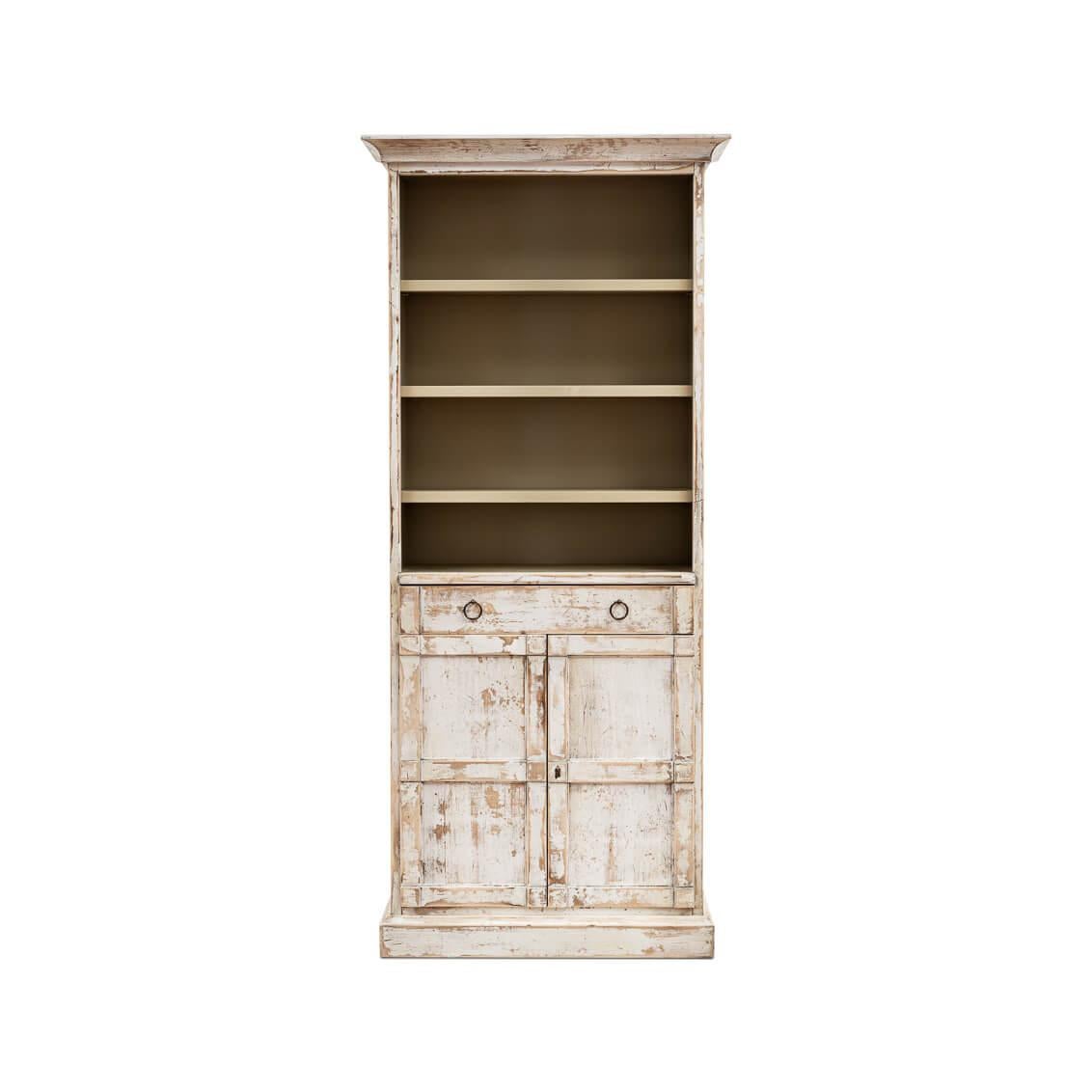 This stately piece stands tall in antiqued and distressed white, offering three open shelves that are perfect for displaying your favorite books, photos, or collectibles. Below, the twin drawers with chic ring pulls provide a safe haven for smaller