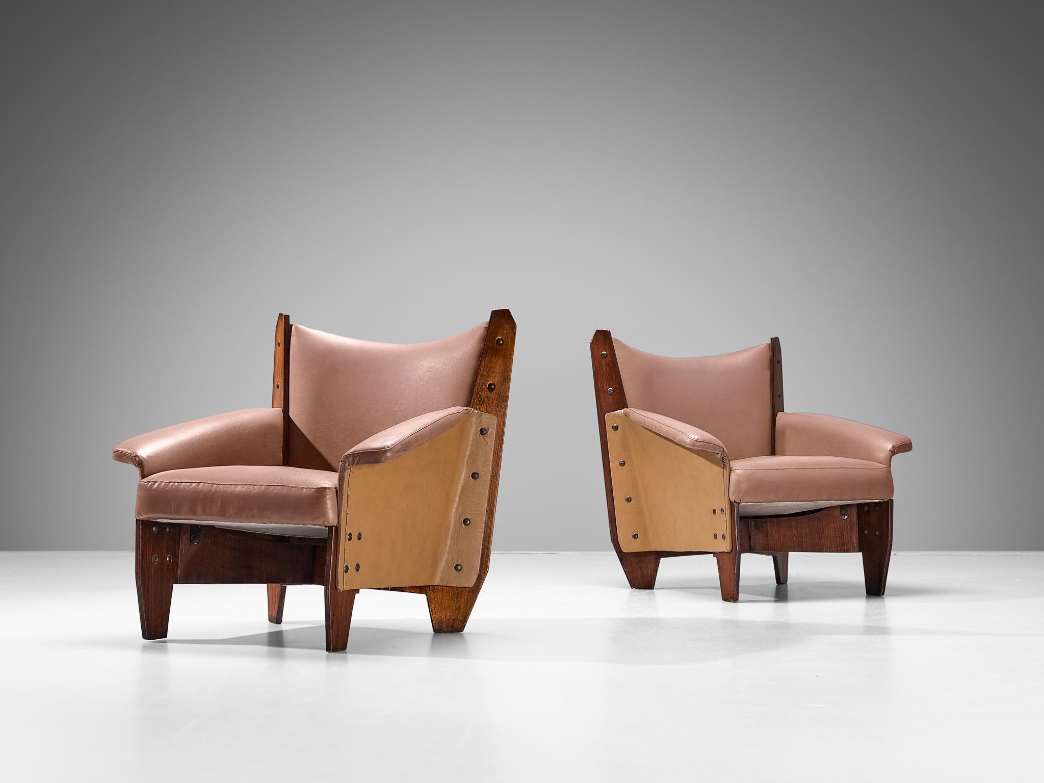 Pair of armchairs, mahogany plywood, faux leather, metal, Italy, 1950s

These easy chairs embody an exquisite form made possible by the inherent quality of the plywood, resulting in sharp, sleek lines and solid geometry. The crescent-shaped