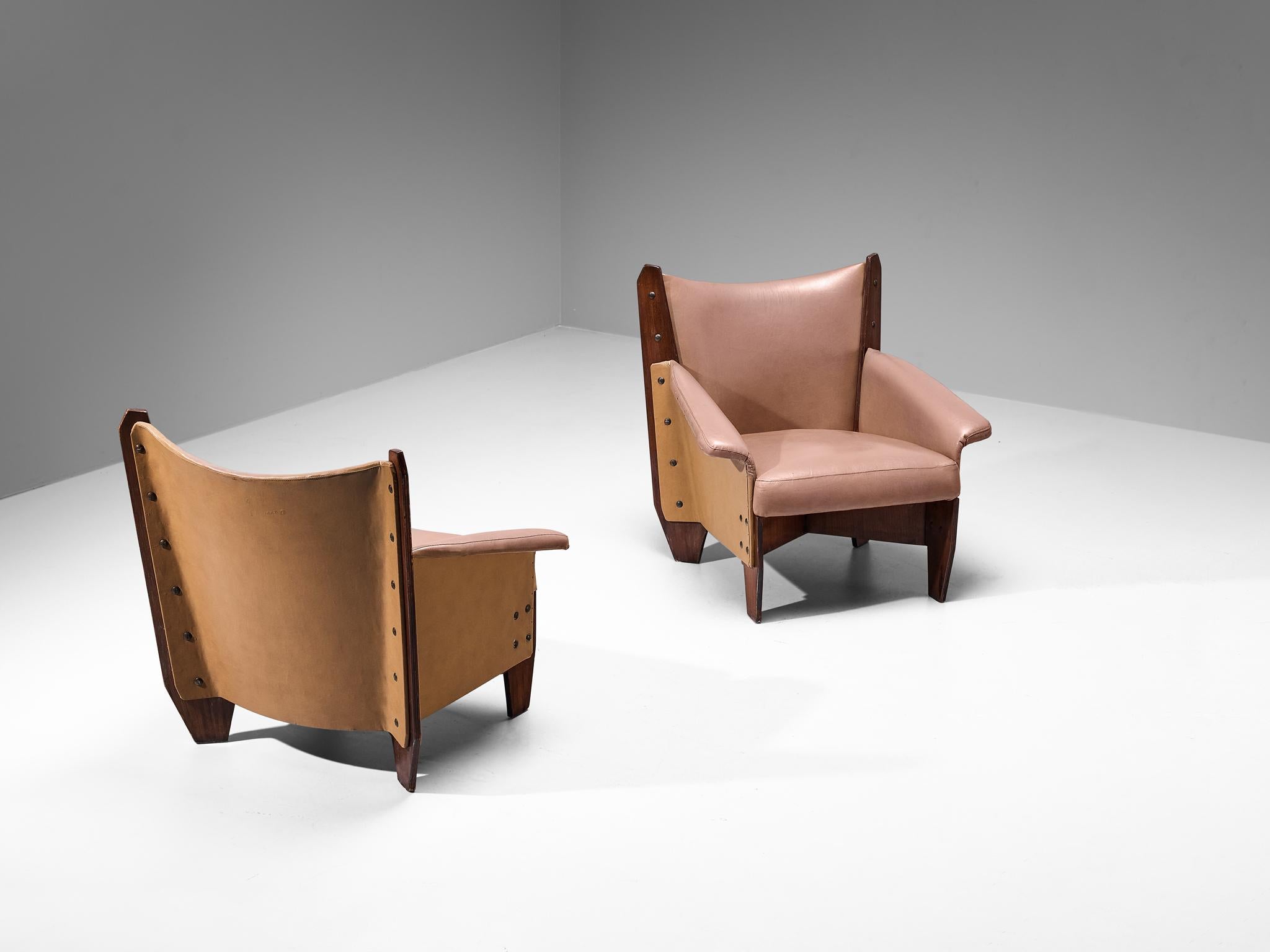 Pair of armchairs, mahogany plywood, faux leather, metal, Italy, 1950s

These easy chairs embody an exquisite form made possible by the inherent quality of the plywood, resulting in sharp, sleek lines and solid geometry. The crescent-shaped