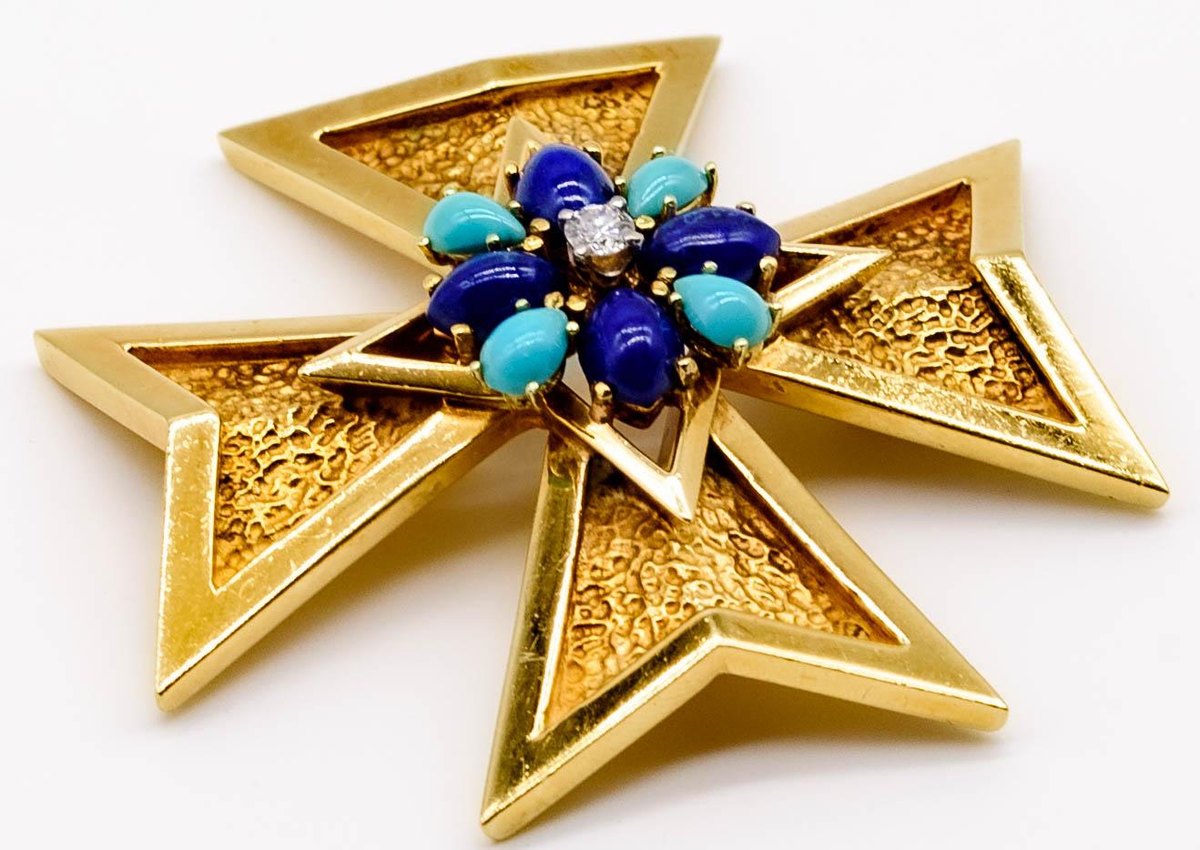Strong in line, color, and style, this elegant Maltese style cross is a perfect accessory not just for the holidays but for any time of year.  Beautifully textured gold arms, all equidistant from the center, surround a center motif of rich navy