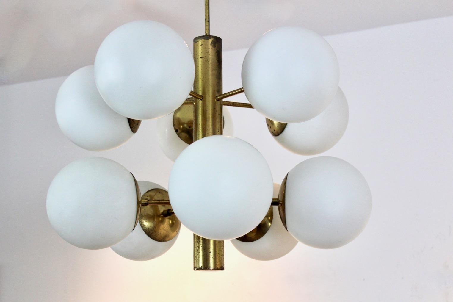 Unique brass chandelier with ten arms and with very nice Opaline Glass Shades. Coming from France, made in the 1970’s. Each arm features one Opaline Glass Bowl, so ten Glass shades in total. All are in good condition as is the whole chandelier. With