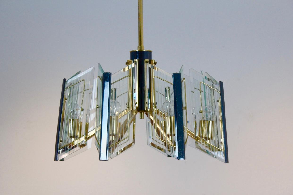 Unique brass chandelier with eight arms and with very nice etched glass shades. Coming from France, made in the 1960s. Each arm features two etched and facet glass pieces, so sixteen glass shades in total. All are in perfect condition as is the