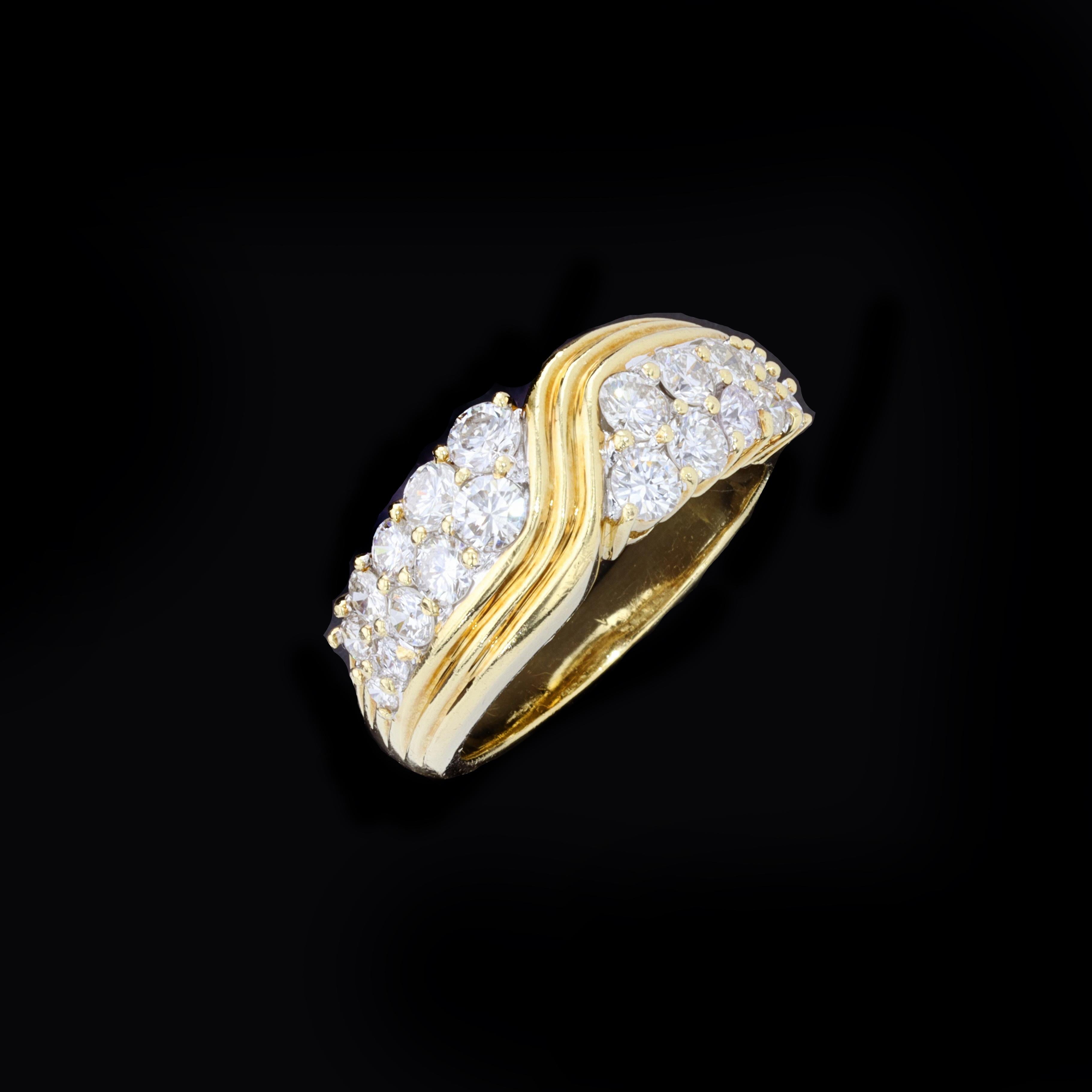 A radiant river of 18K yellow gold flows through the sparkle of icy round diamonds in this retro ring. This ring features 20 round F VS1 diamonds weighing 1.50 ctw, and is currently sized to 7.

