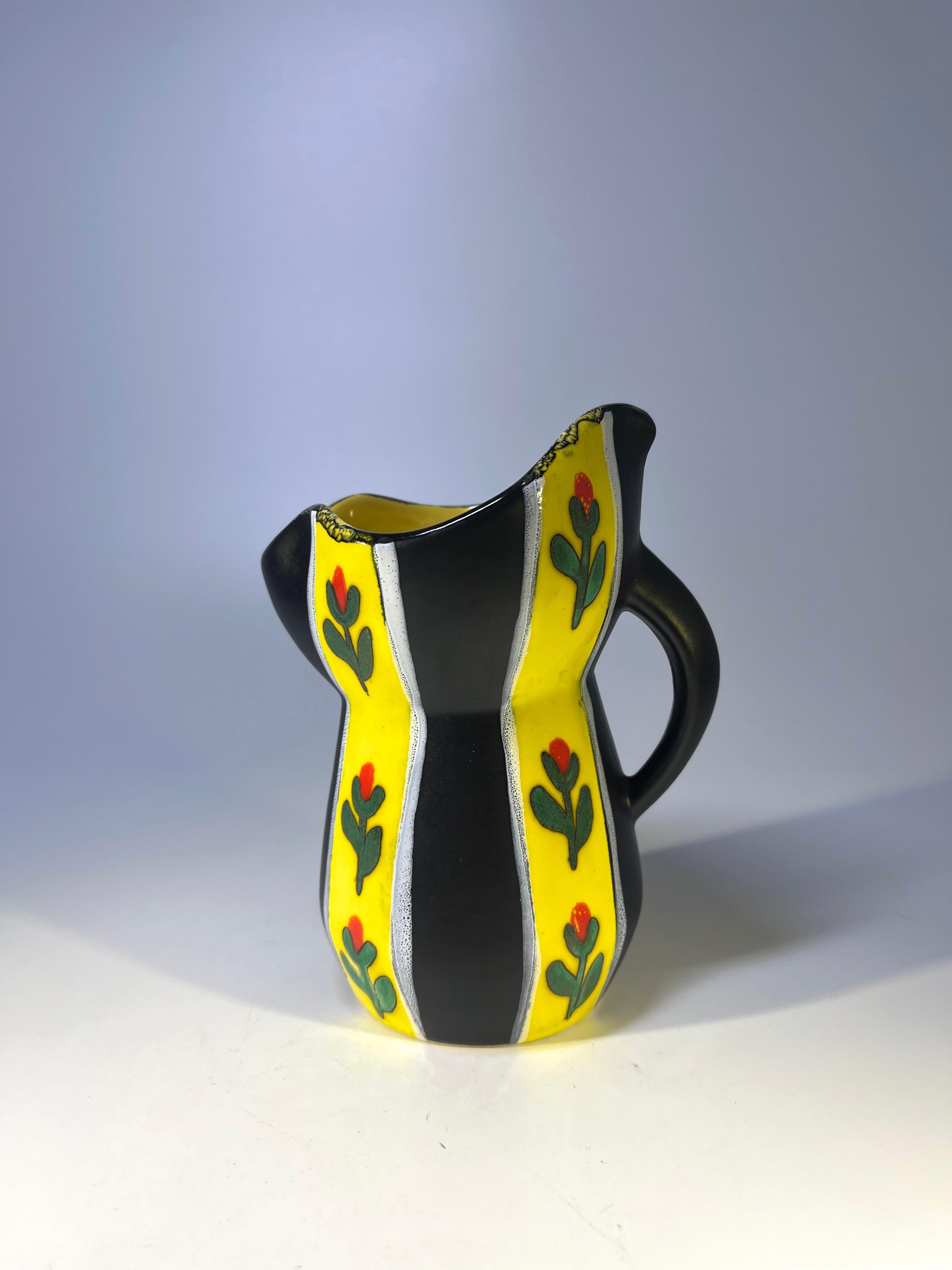 Striking yellow and black glazed pitcher, decorated with stylised flowers.
Bright yellow glaze to interior.
Fourmaintraux's unmistakable artistry makes this a great collectors piece.
Signed to base.
Circa 1950's.
Measures: height 5 inch, width