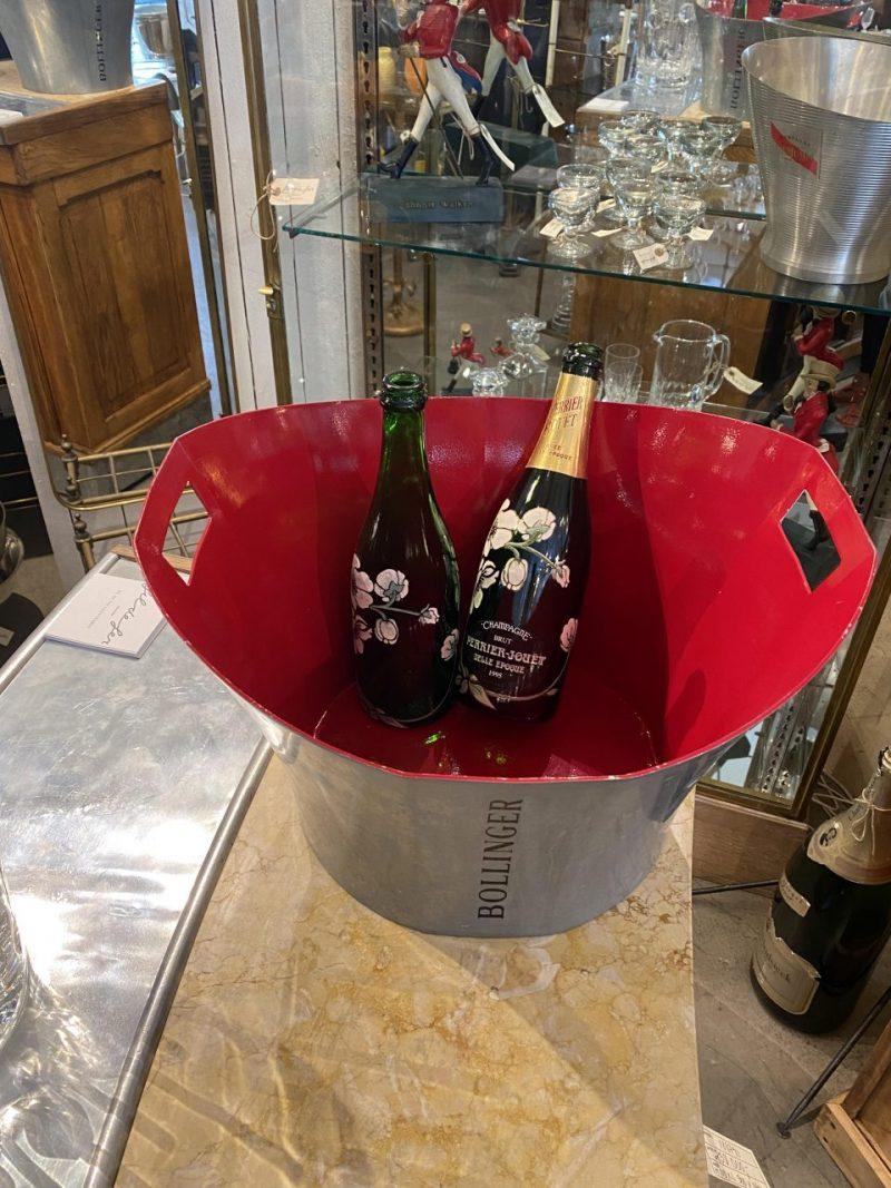 Fantastic large authentic Bollinger champagne cooler, from France.

This beautiful and rare piece was designed by Eric Berthès, and formed in pewter with a  super red glossy lacquered inner.

The champagne cooler has the company’s name and logo on