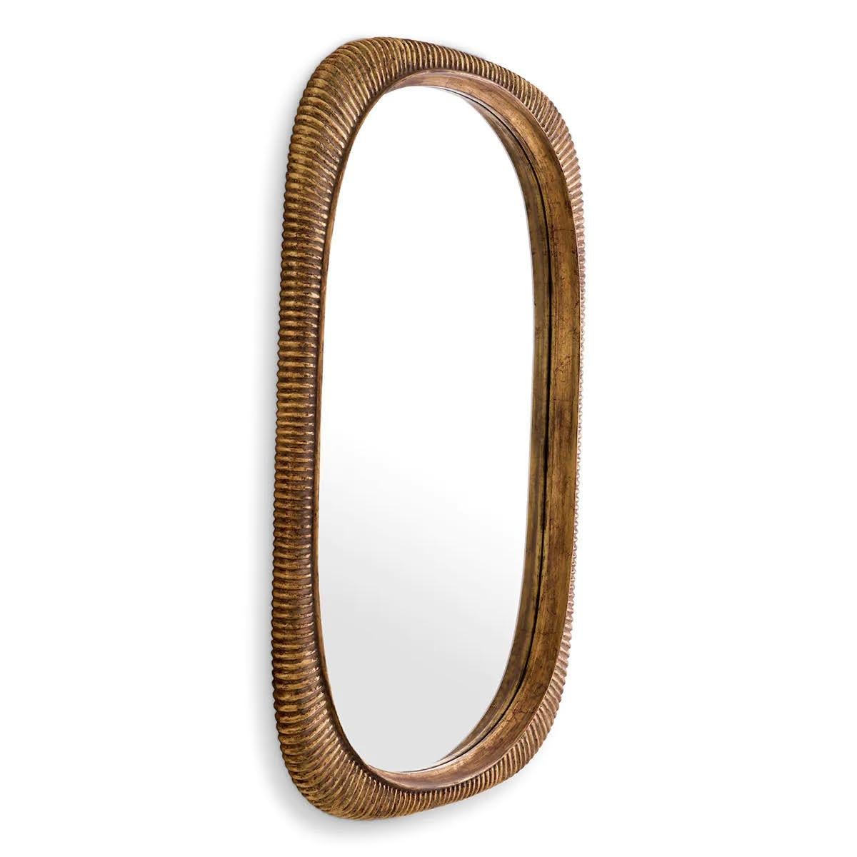 The ribbed frame of this mirror is skilfully hand-carved from mahogany wood and finished with an antique gold finish.

The exterior of the frame is rectangular with rounded corners, while the interior is oval-shaped. This beautiful decorative mirror