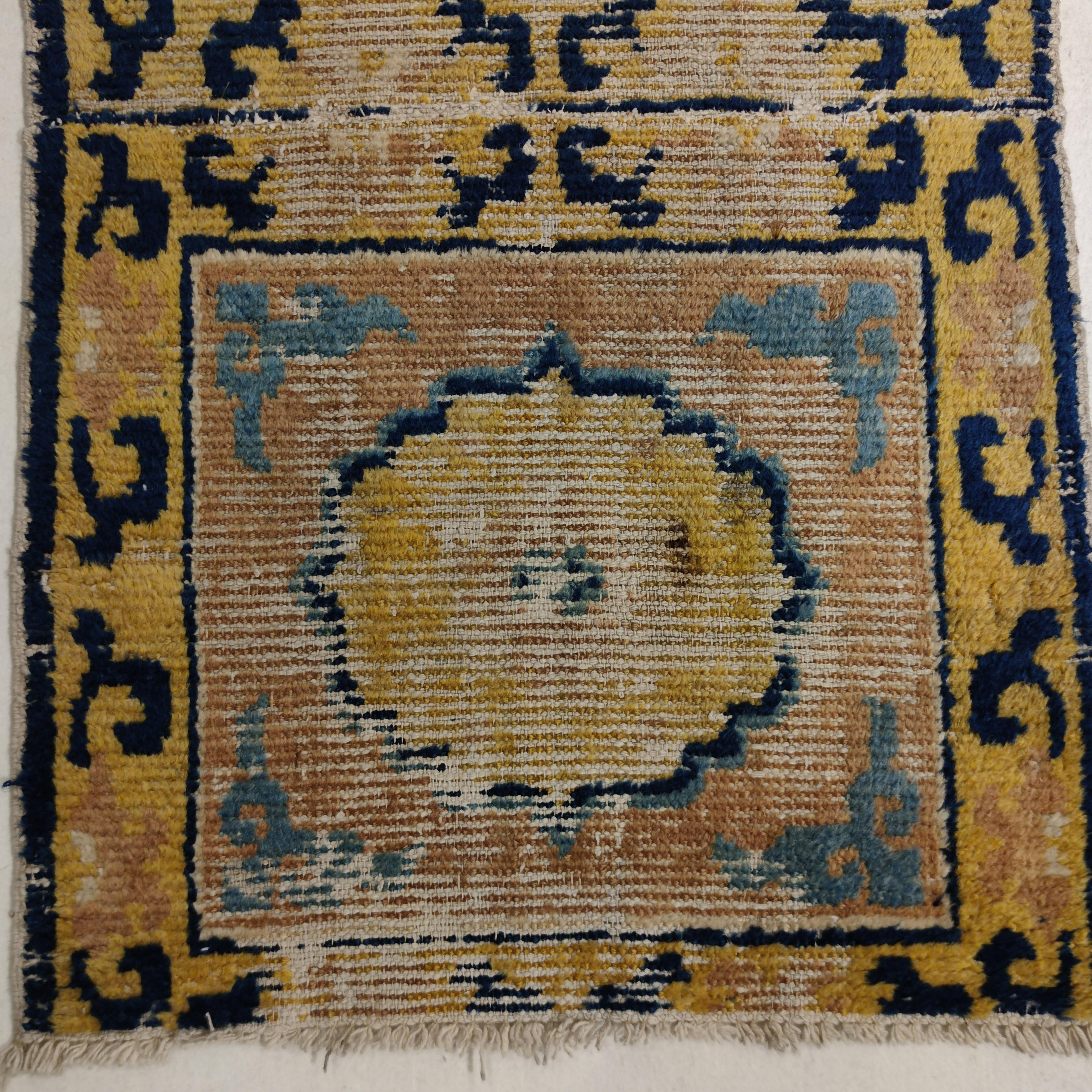 An exquisitely elegant early Temple runner from the Ningxia region in northwest China, commissioned in the early 18th century for a Buddhist monastery in Tibet. The pattern is composed of seven squares, each of which was to be used as a meditation