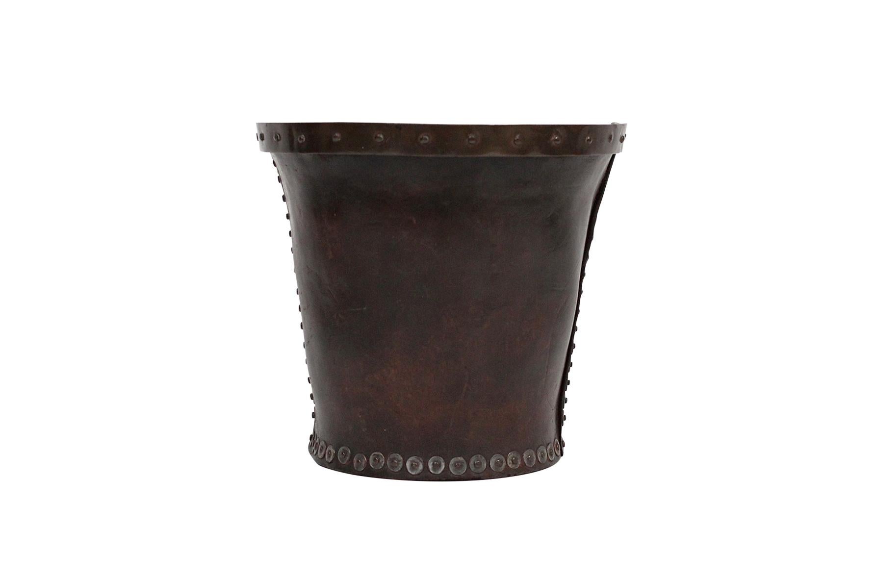 Late 19th early 20th century leather wastebasket with copper trim and steel rivets.