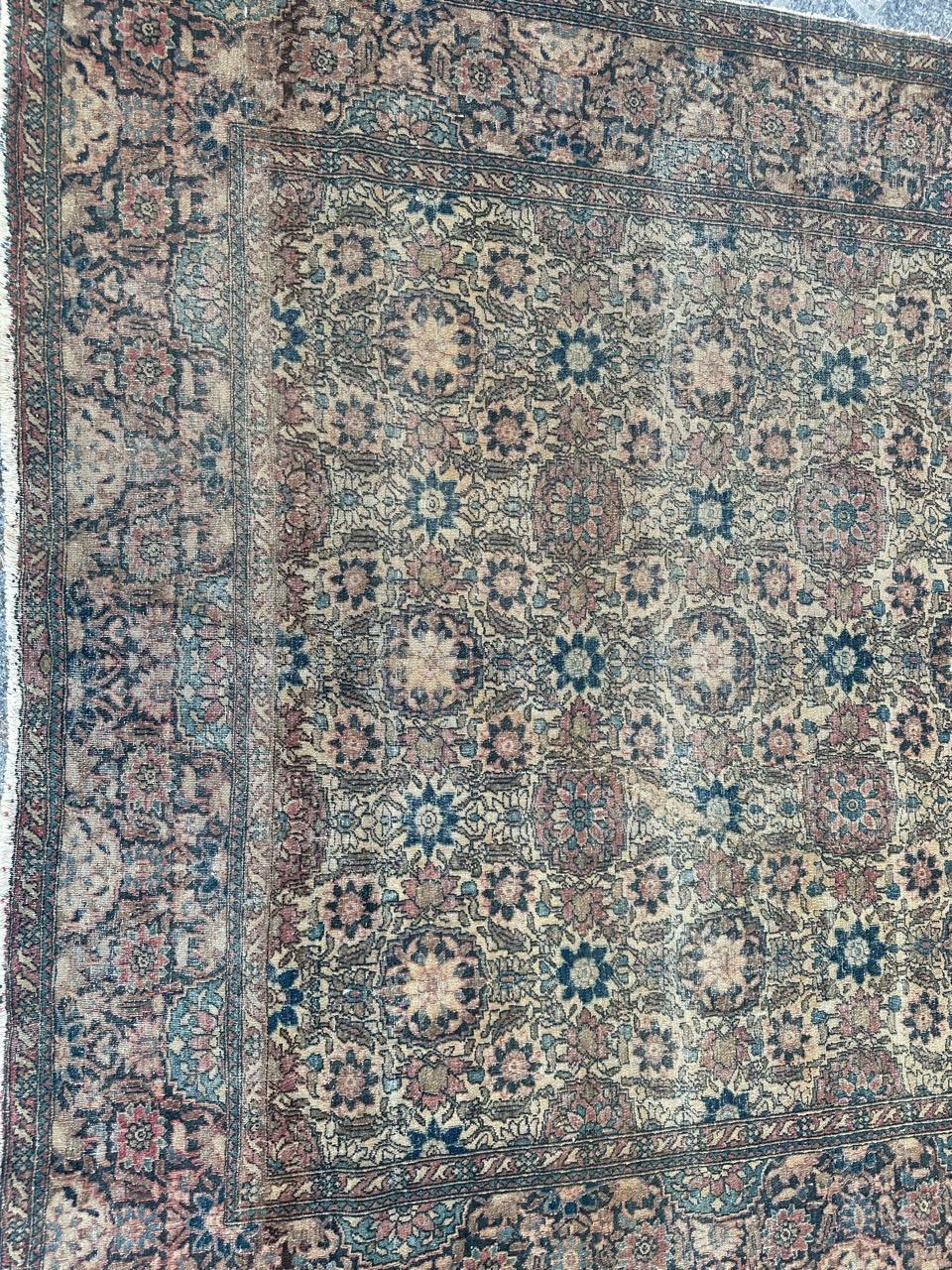 Discover the timeless elegance of a late 19th-century Ispahan antique rug. Meticulously hand-knotted with wool on a cotton foundation, this masterpiece features intricate floral field Adorned with stylized flowers, in a palette of yellow , pinks,