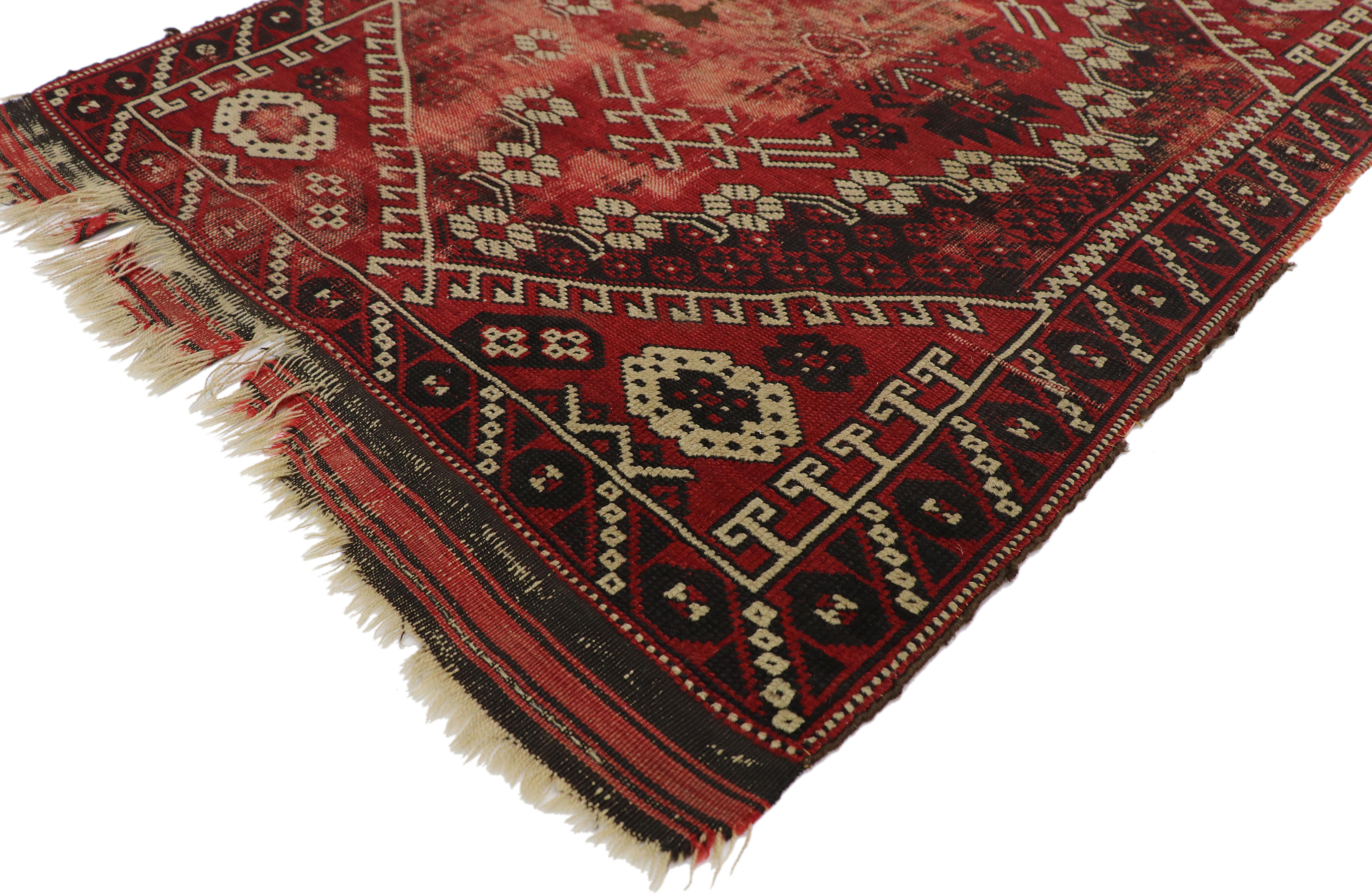 76628, distressed antique Afghani rug with Adirondack Lodge Style 02'11 x 03'10. This hand knotted wool distressed antique Afghani rug features a large-scale lozenge composed of four petaled flowers alternating with curved sickle leaves and