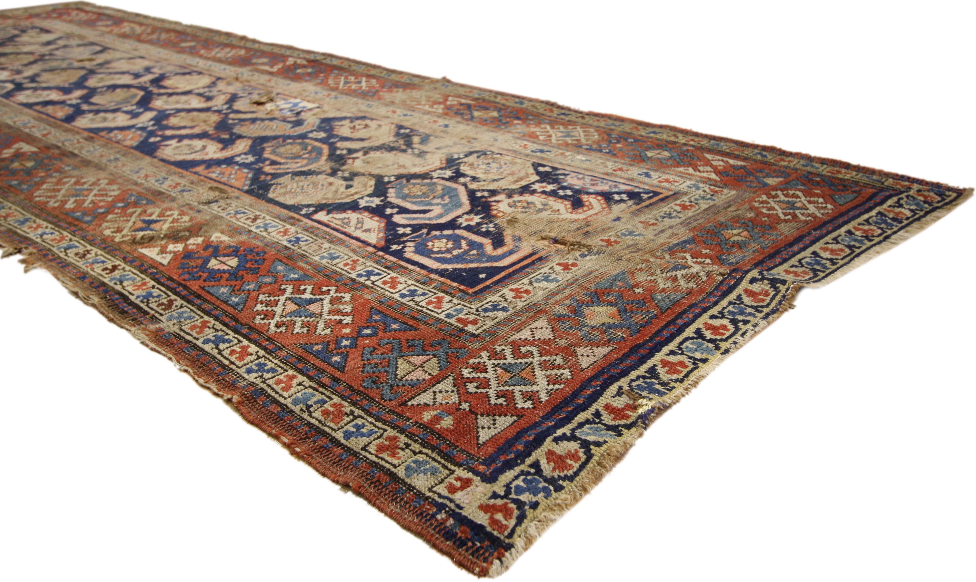 76609, distressed antique Caucasian Shirvan Boteh carpet runner. With its perfectly worn-in charm and edgy elements, this antique Caucasian Shirvan runner will create a warm, lived-in look and take on a curated look that feels timeless while