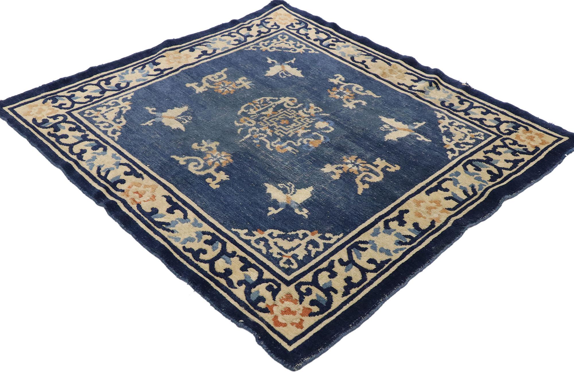 77561, distressed antique Chinese Peking rug with Romantic chinoiserie style1. This hand knotted wool distressed antique Chinese Peking rug features a rounded open center medallion floating on an abrashed blue field. The medallion is comprised of a