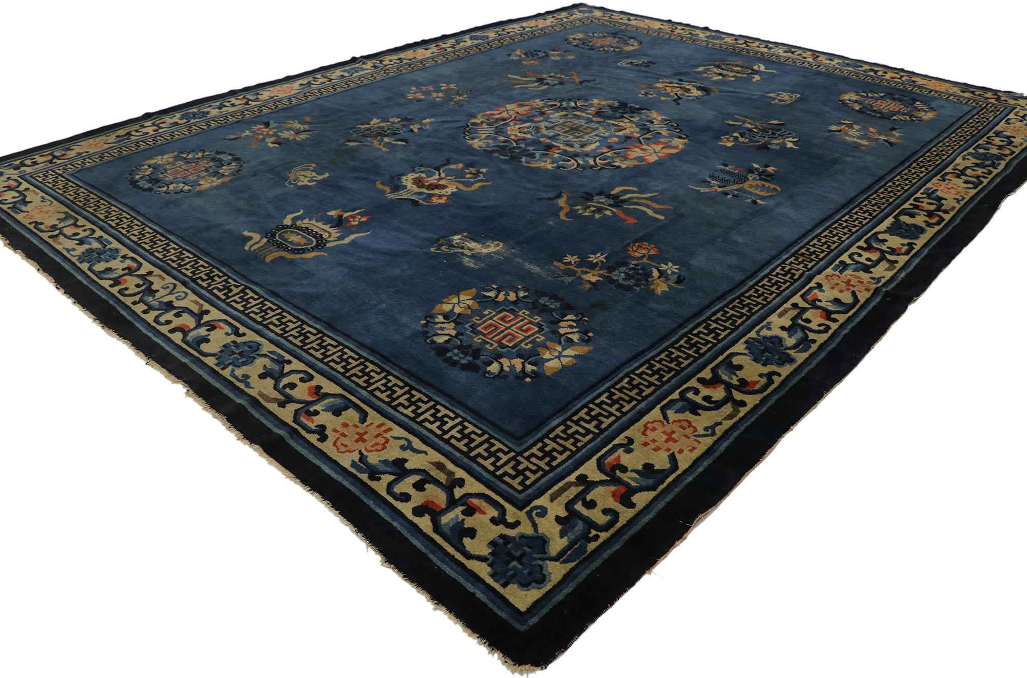 77544 Antique Chinese Peking Rug, 09'00 x 11'05. This antique Chinese Peking rug, meticulously hand-knotted from wool, showcases a striking design with a rounded medallion gracefully positioned at the center of an abrashed sapphire blue field,