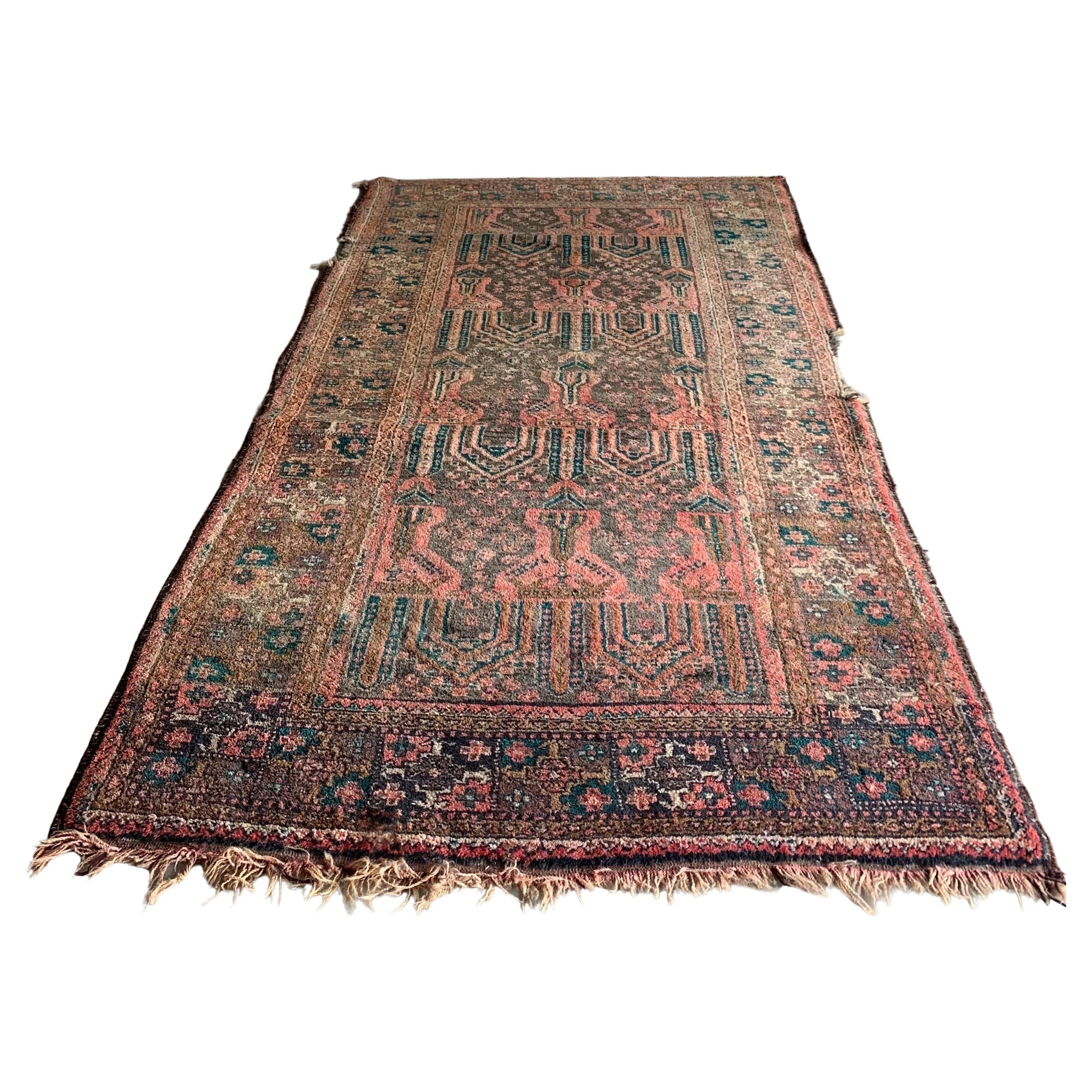 Over 100 yr old antique rug. 7ft long by 3ft & 1/2 wide. Distressed in some area, still holds its beautiful patterning & color.