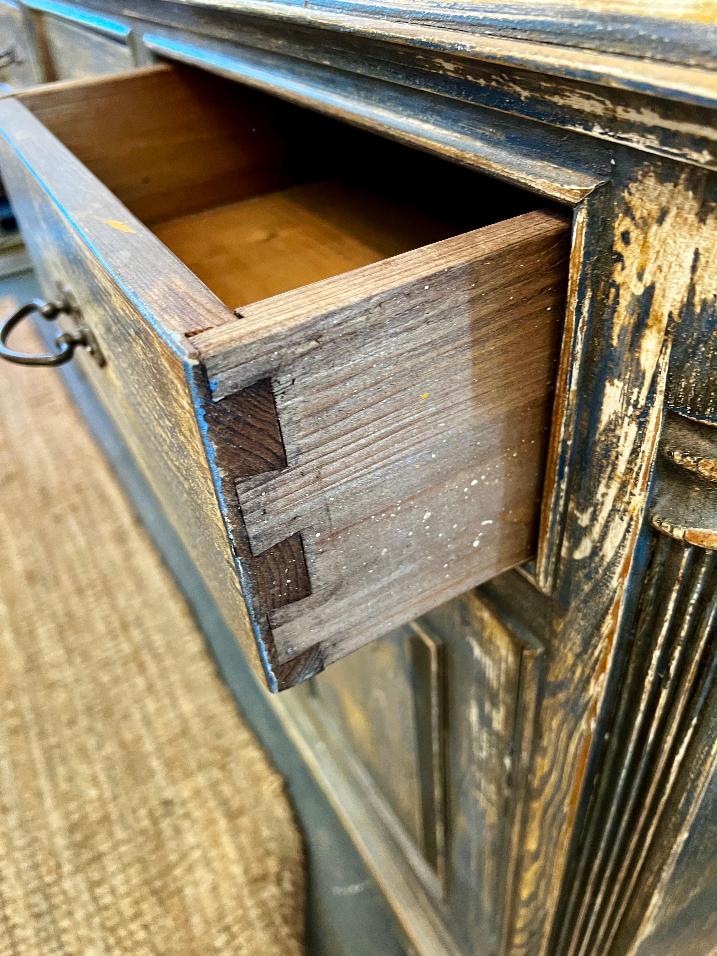What sets this antique sideboard/server apart is the hand-painted color which is a blue/white color scheme and distressed.  Plenty of storage.  Great scale and better lines.  Perfect for a beach house.
