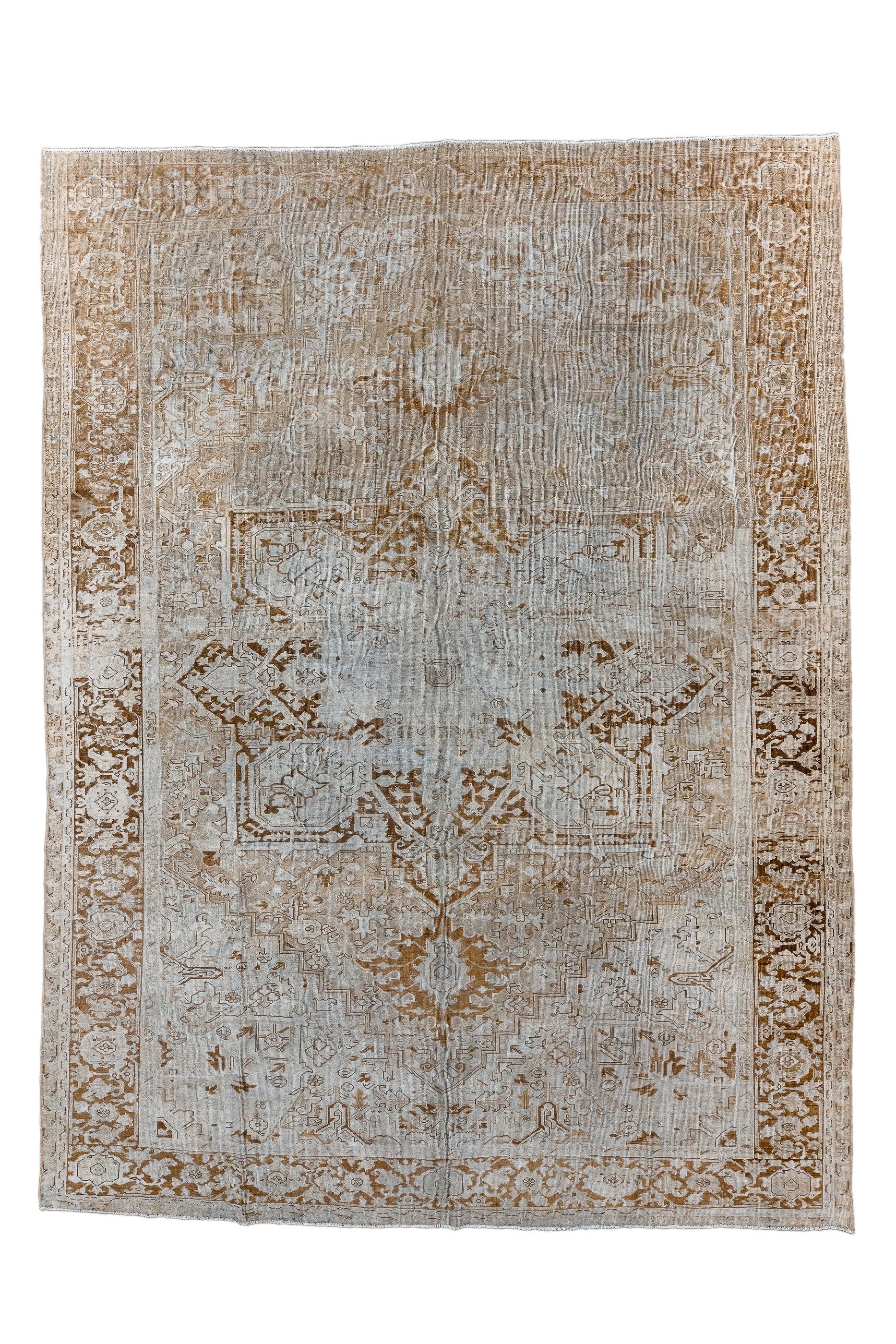 Somewhat distressed, with a light overall palette, this coarsely woven village carpet shows  a pendanted, near black octogramme medallion on a rose-terra cotta field.  Stepped ecru corners.  Brick strip style main border with standard reversing