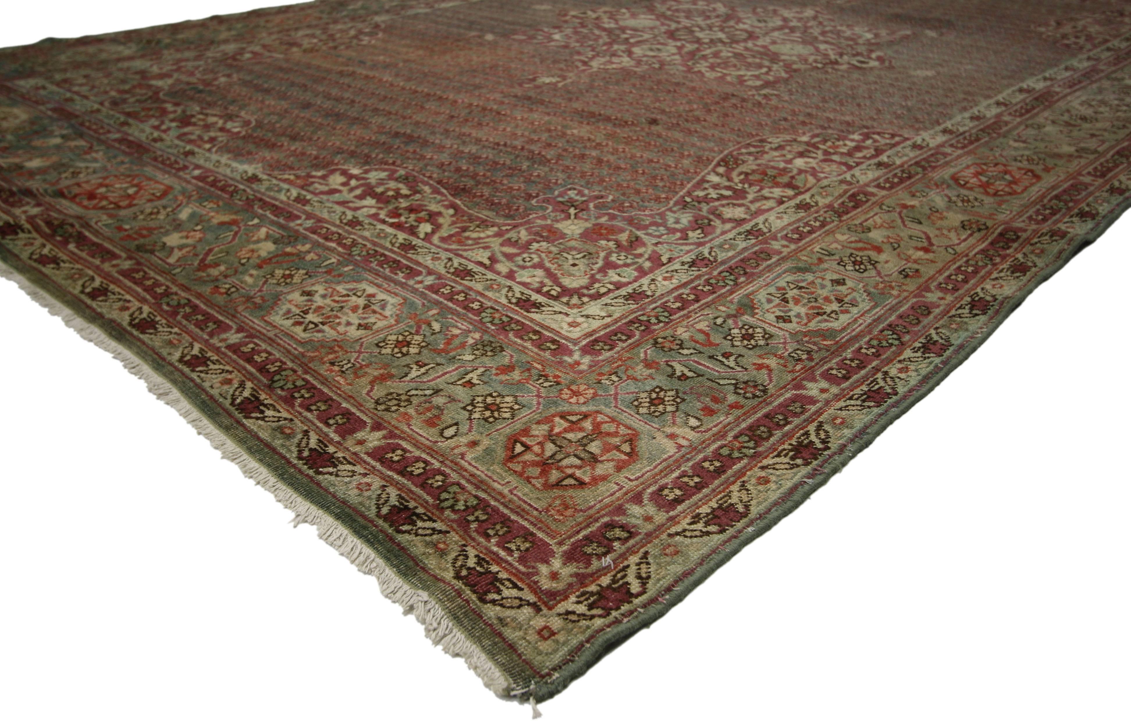 71466 Distressed Antique Indian Agra Rug with Rustic Jacobean Old World Style 07'03 x 10'10. Ravishing and refined with beguiling ambiance, this hand-knotted wool distressed antique Agra rug showcases an ornate eight-point cusped trefoil medallion