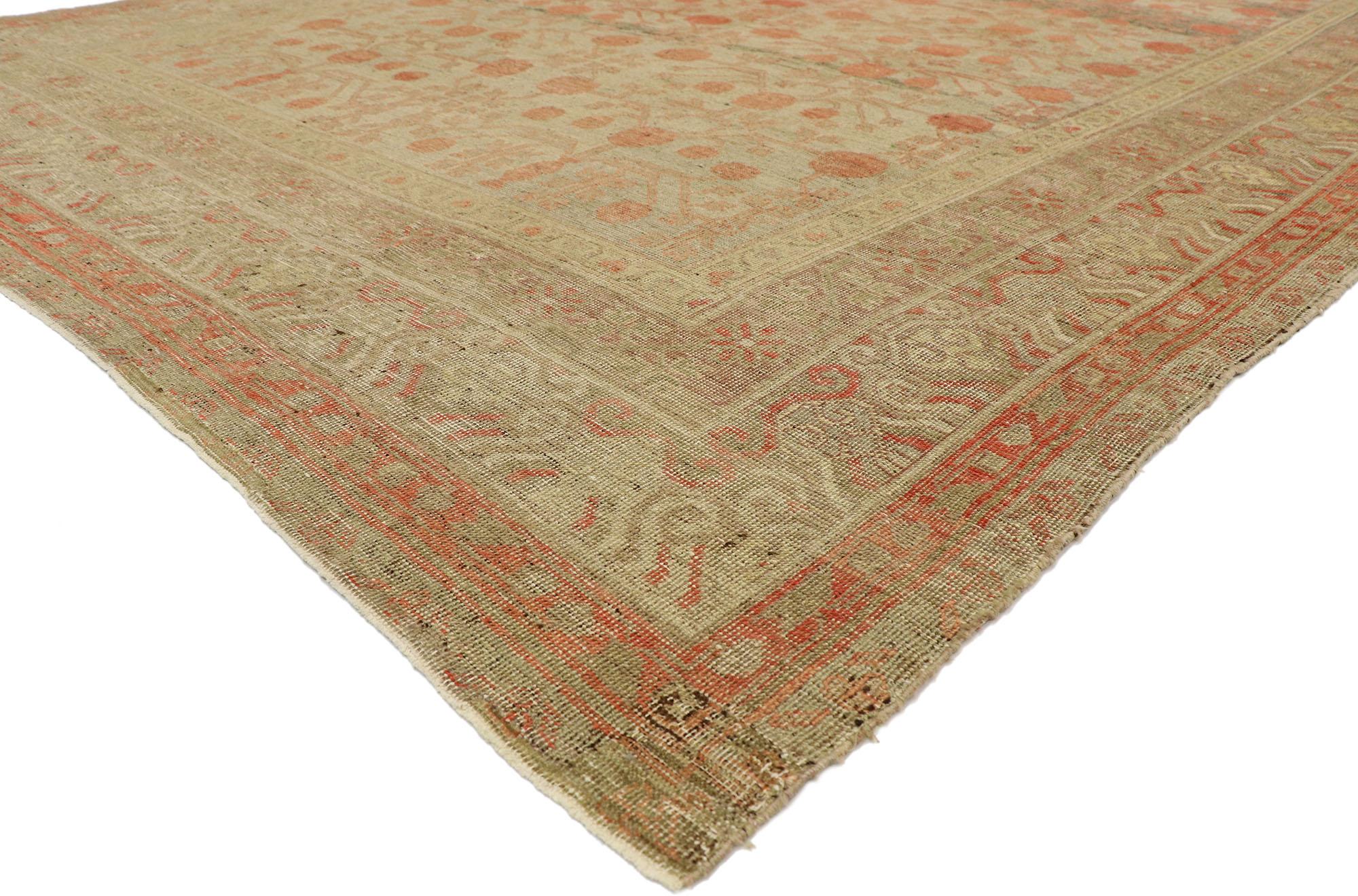 74841, distressed antique Khotan Gallery rug with Pomegranate design. With its striking appeal and architectural elements of naturalistic forms, this hand knotted wool distressed antique Khotan rug can beautifully blend modern, traditional, and