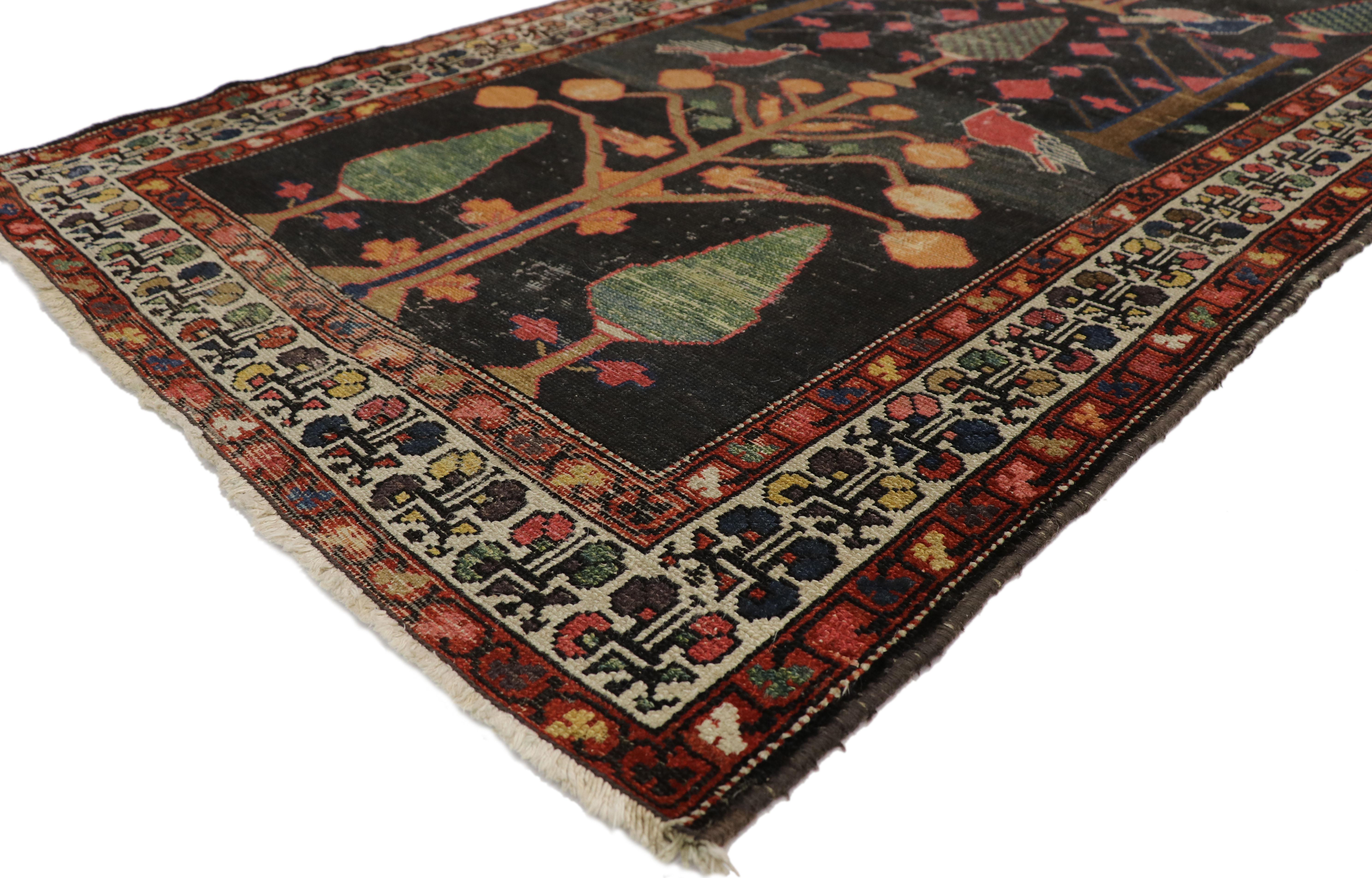 77349, distressed antique Persian Bakhtiari runner with directional Tree of Life design. This hand knotted wool distressed antique Persian Bakhtiari rug runner features a tree of life design spread across an abrashed and weathered field. The tree of