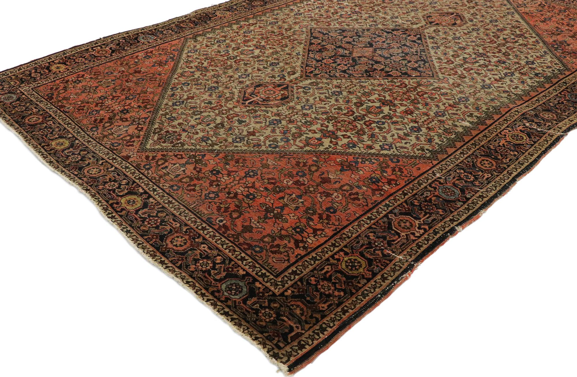 77530, distressed antique Persian Farahan rug withy rustic craftsman style. With its geometric pattern and lovingly time-worn composition, this hand knotted wool distressed antique Persian Farahan rug embodies a rustic craftsman style. The weathered