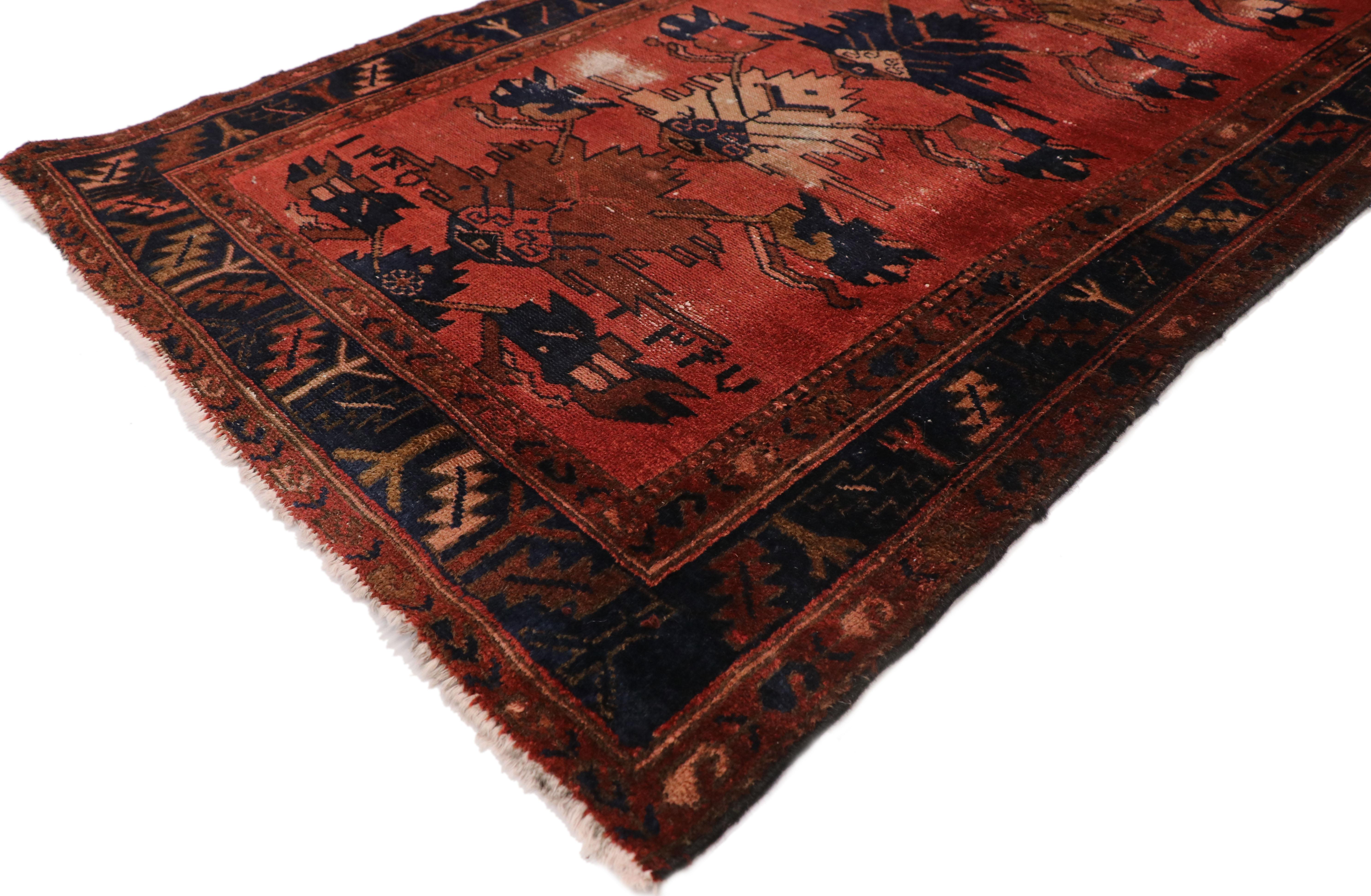 77409 distressed antique Persian Hamadan runner with rustic English Manor Tudor style. With its warm, rich colors and ornate detailing, this hand knotted wool distressed antique Persian Hamadan runner is poised to impress. It features naturalistic