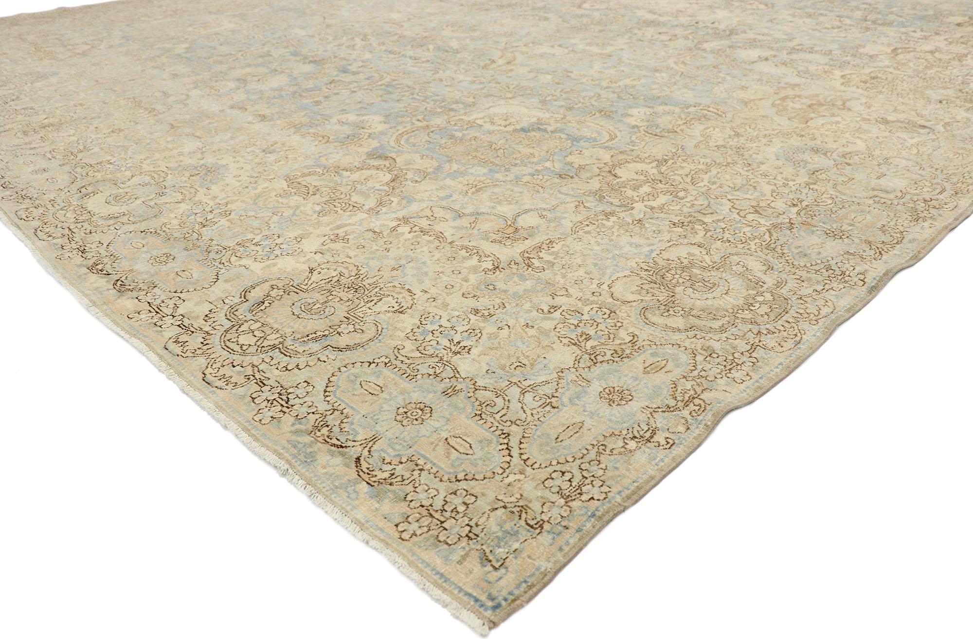 77167, distressed antique Persian Kerman palace rug with Cotswold country cottage style. With a timeless floral pattern and lovingly timeworn appearance, this hand knotted wool distressed antique Persian Kerman rug charms with ease and beautifully