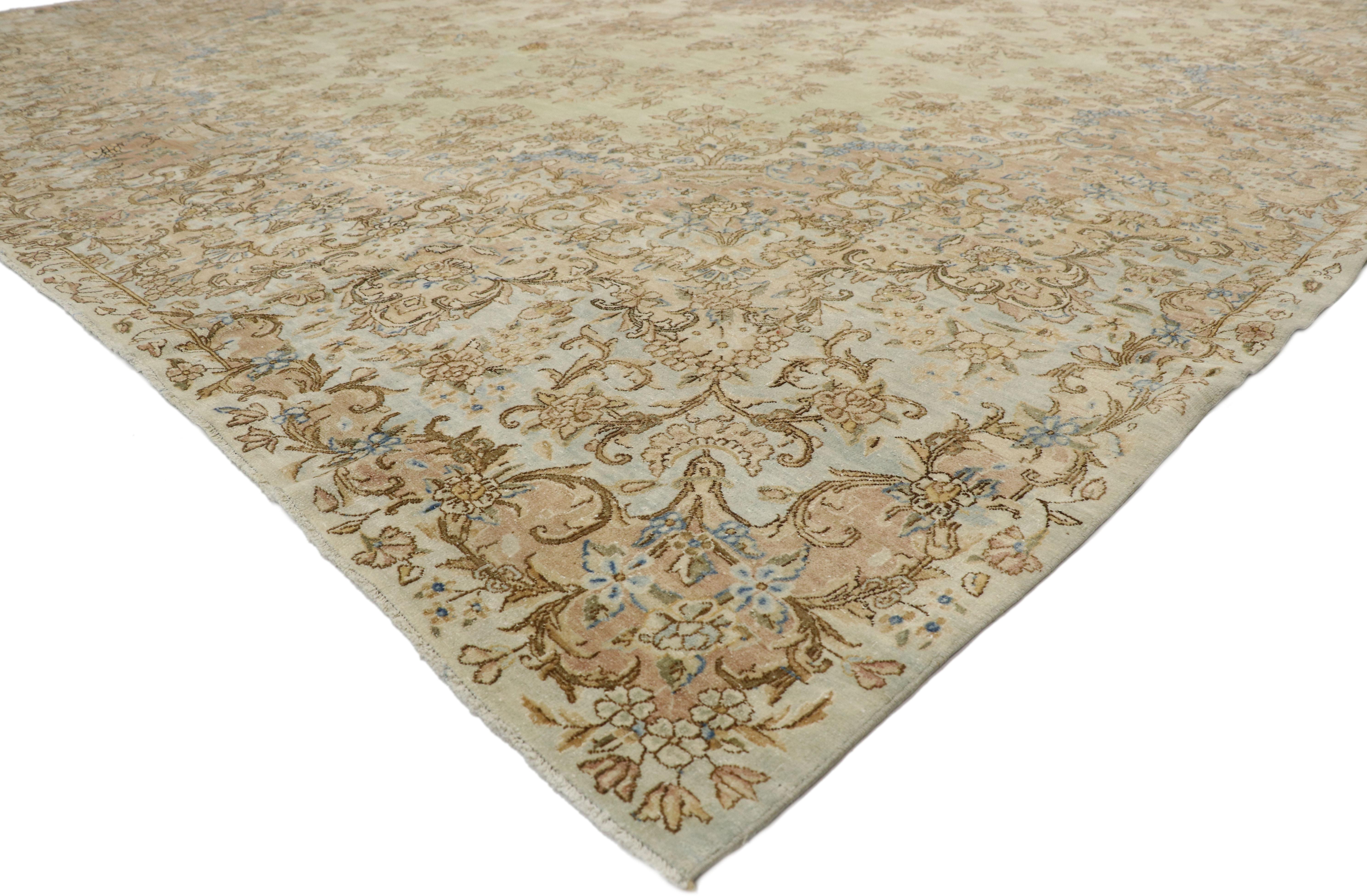 73493, distressed antique Persian Kerman rug with French Provincial and Georgian style. With an impressive array of realistic floral elements and lovingly timeworn appearance combined with harmonious and subtle hues, this hand knotted wool