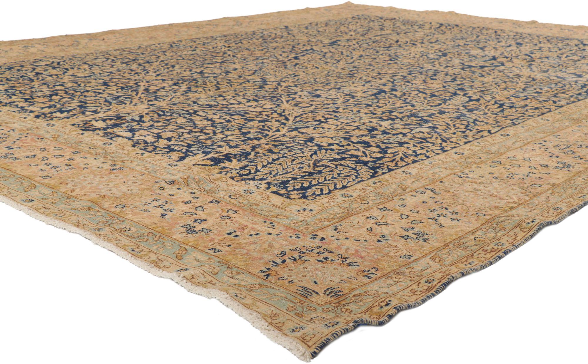 53732 Distressed Antique Persian Kerman Rug with Millefleur Design 08'08 x 11'05. With a traditional floral design and rugged beauty, this hand-knotted wool distressed antique Persian Kerman rug beautifully highlights nostalgic charm. The lovingly