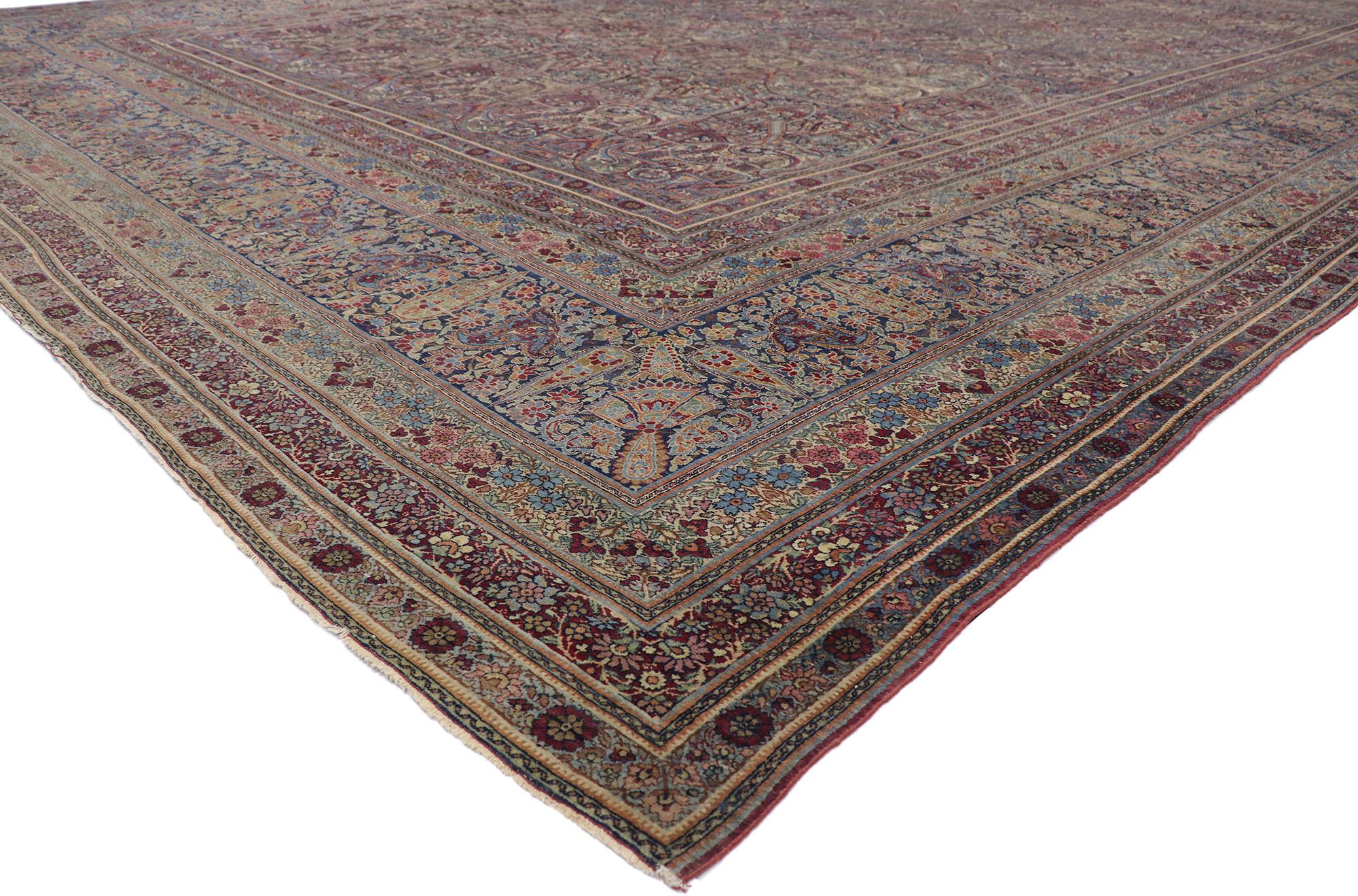 77622 distressed antique Persian Lavar Kerman rug with Rustic English Country style. Full of tiny details and a boteh paisley design combined with time-softened colors, this hand-knotted wool distressed antique Persian Lavar Kerman rug is a