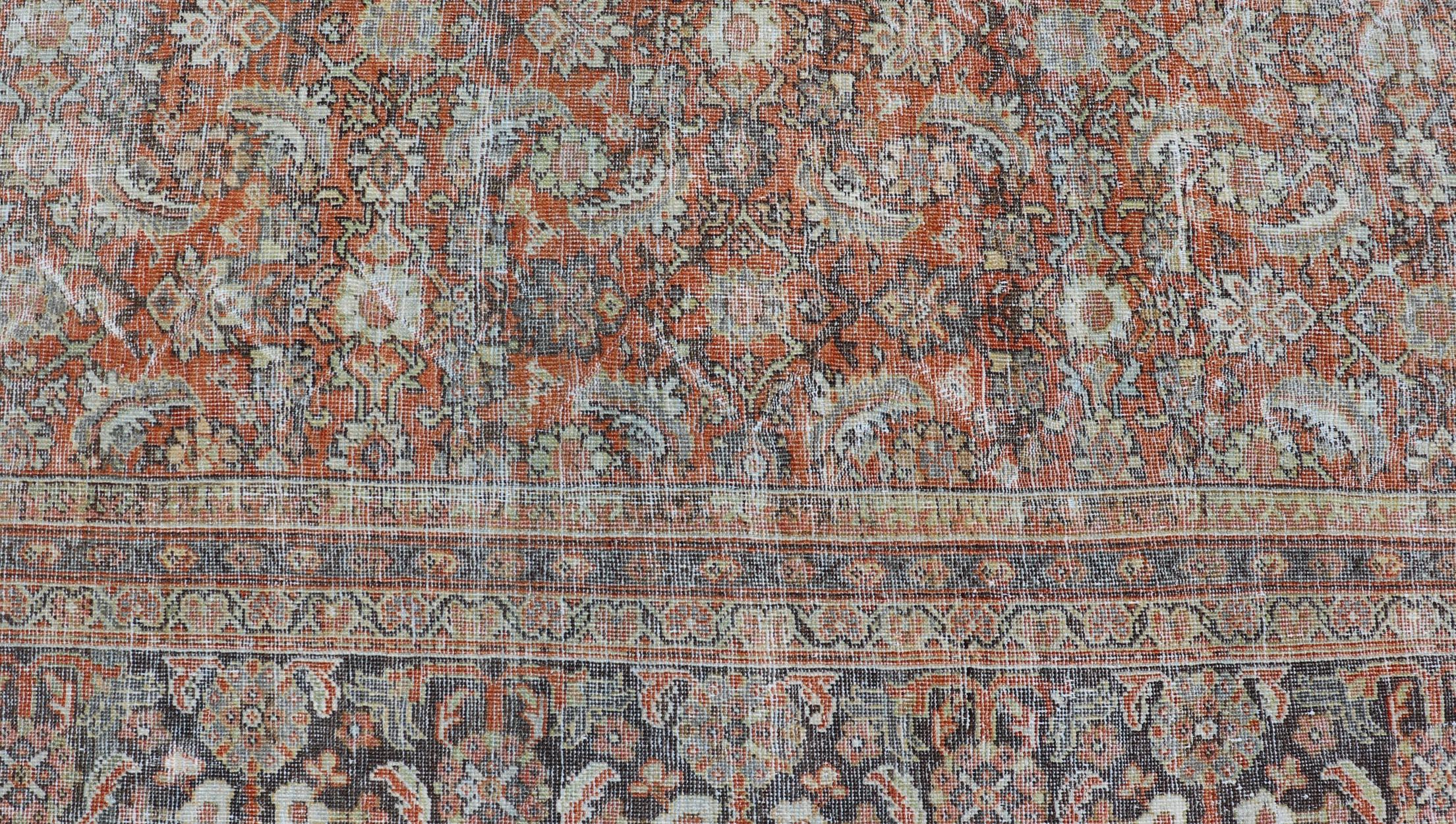 Distressed Antique Persian Mahal Rug in Wool with Floral Design on a Red Field In Good Condition For Sale In Atlanta, GA