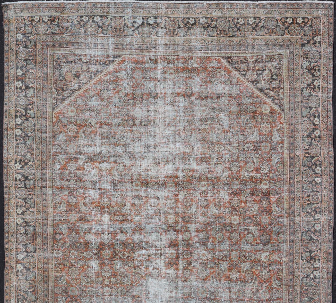 20th Century Distressed Antique Persian Mahal Rug in Wool with Floral Design on a Red Field For Sale