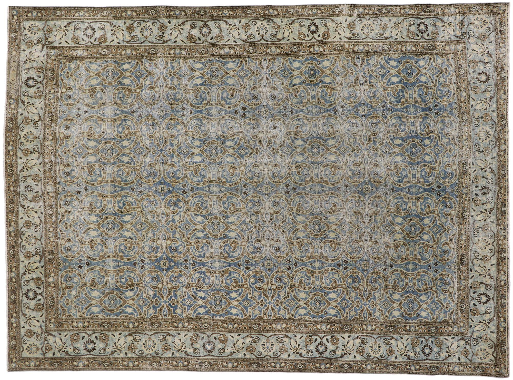60940 Distressed Antique Persian Mashhad rug 08'09 x 12'00. Effortlessly chic and emanating coastal vibes with rustic sensibility, this hand knotted wool distressed antique Persian Mashhad rug beautifully is a captivating vision of woven beauty. The