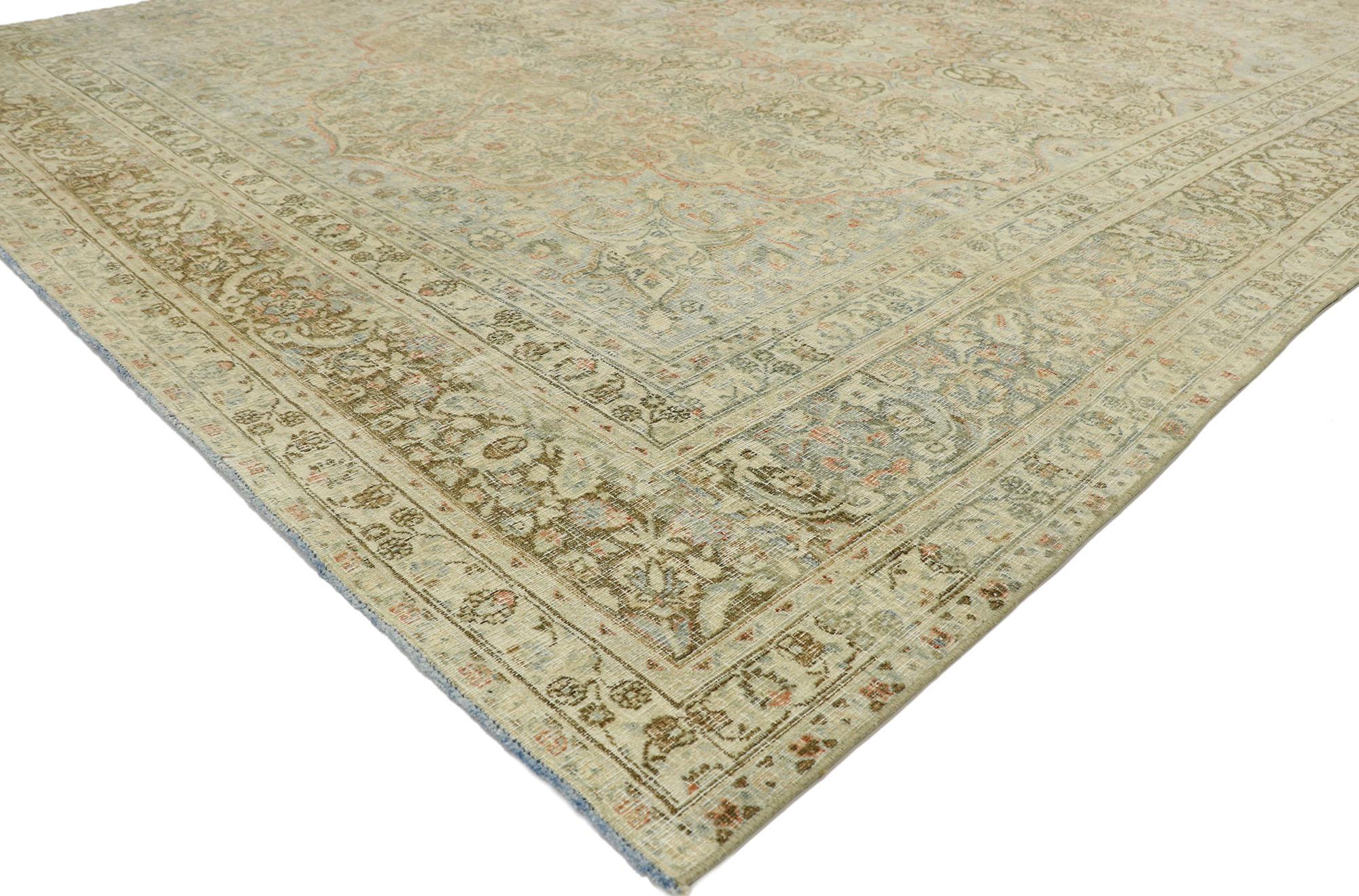 53219, distressed antique Persian Mashhad rug with modern rustic Cotswold cottage style. With a timeless botanical pattern and lovingly timeworn appearance, this hand knotted wool distressed antique Persian Mashhad rug charms with ease and