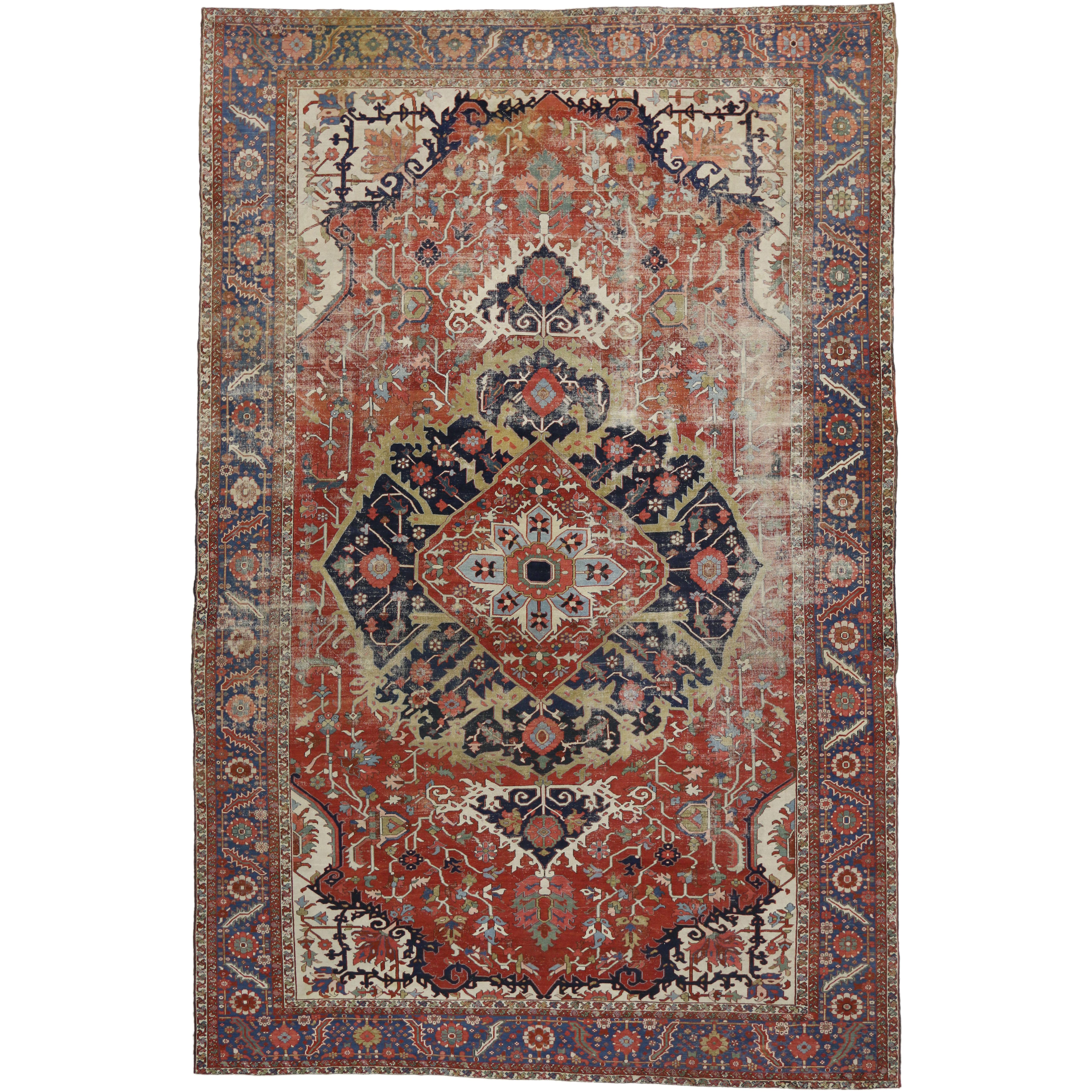 Antique-Worn Persian Serapi Rug, Rustic Charm Meets Relaxed Refinement For Sale