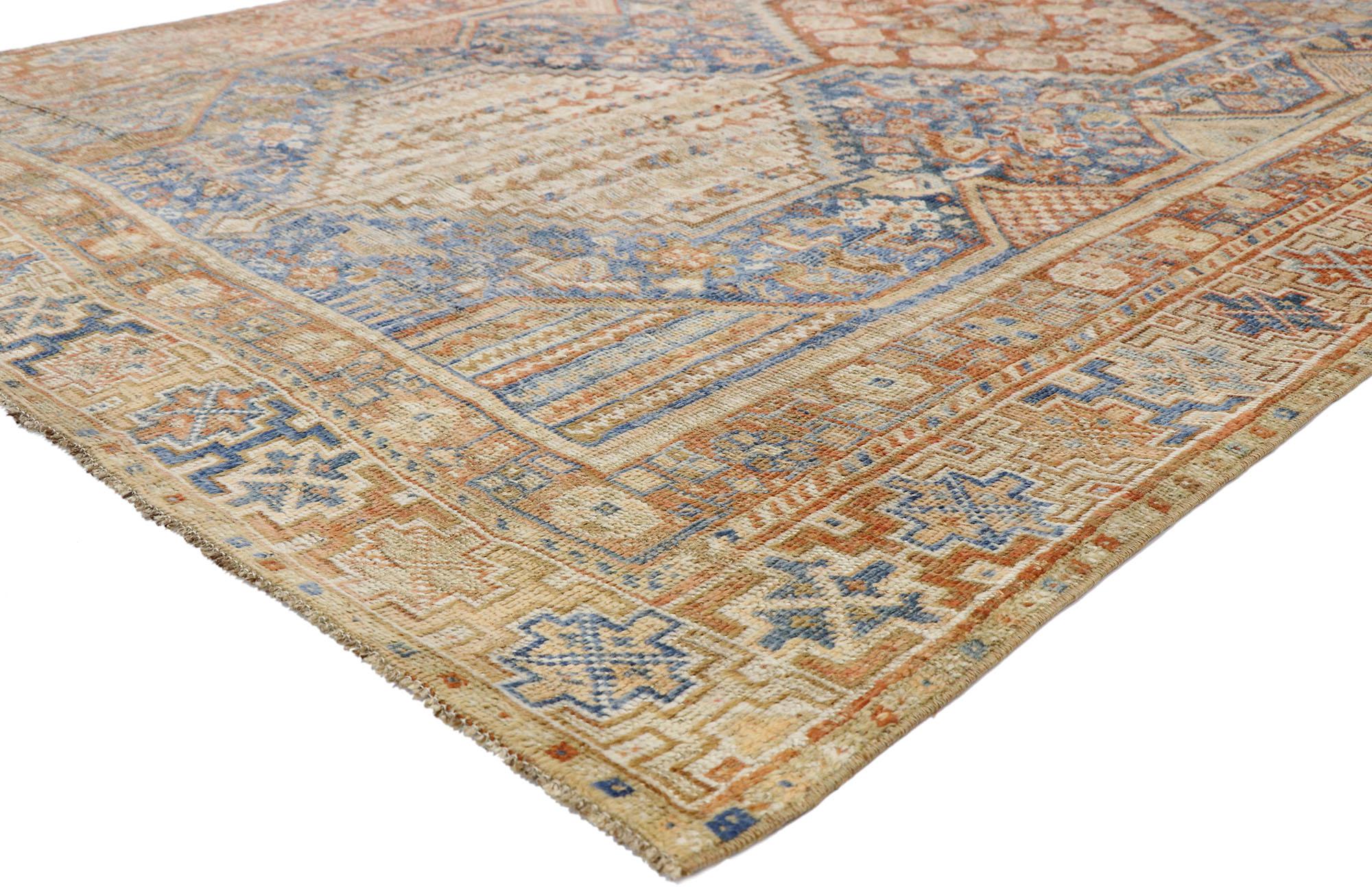 52677, distressed antique Persian Shiraz Design rug with Italian cottage rustic style. With brilliant blues and warm terracotta hues inspired by Italy, this hand knotted wool antique Persian Shiraz rug beautifully embodies an Italian Rustic style.
