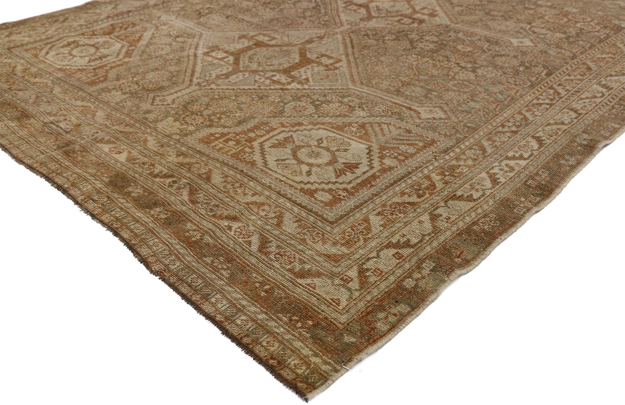 52434, distressed antique Persian Shiraz rug with American Craftsman Rustic style. This understated and subtle antique Persian Shiraz rug features an angular pole medallion with lozenges and extended anchor pendants surrounded by a variety of