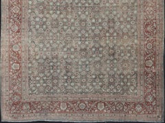 Distressed Antique Persian Sultanabad Rug in Faded Blue Background