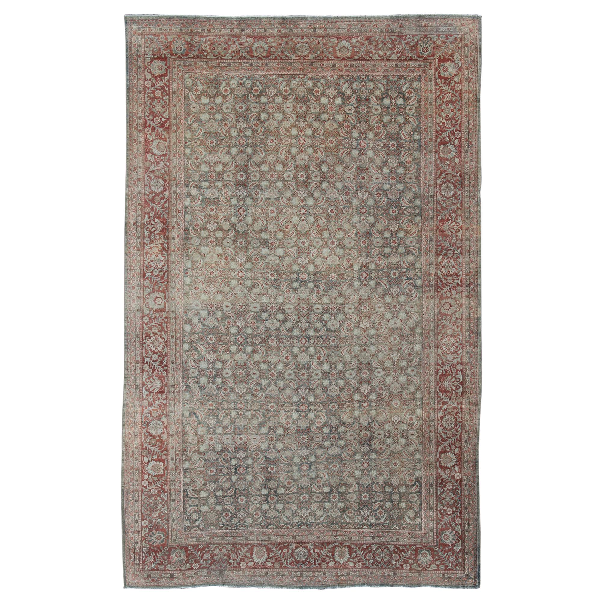 Distressed Antique Persian Sultanabad Rug in Faded Blue Background For Sale