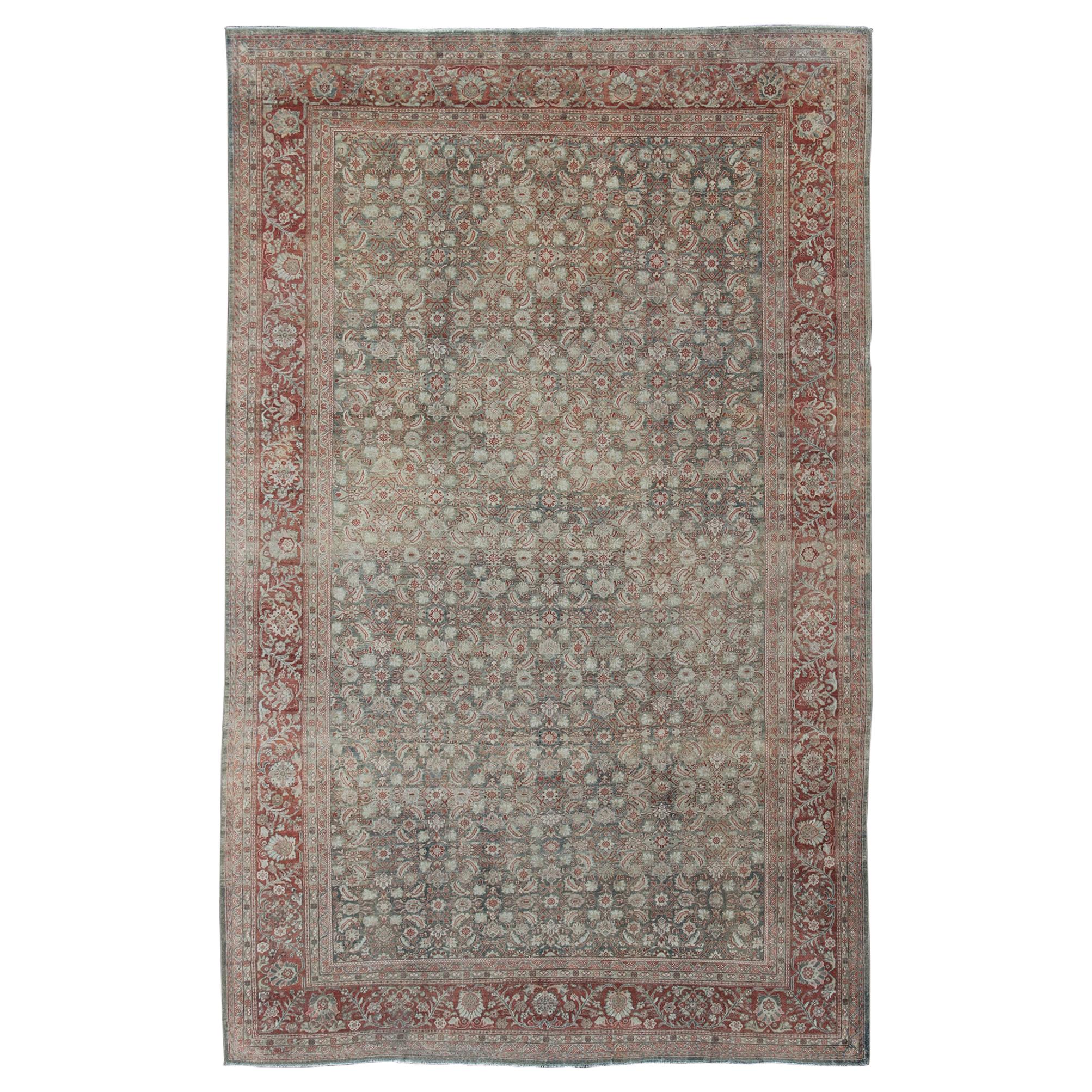Distressed Antique Persian Sultanabad Rug in Faded Blue Background