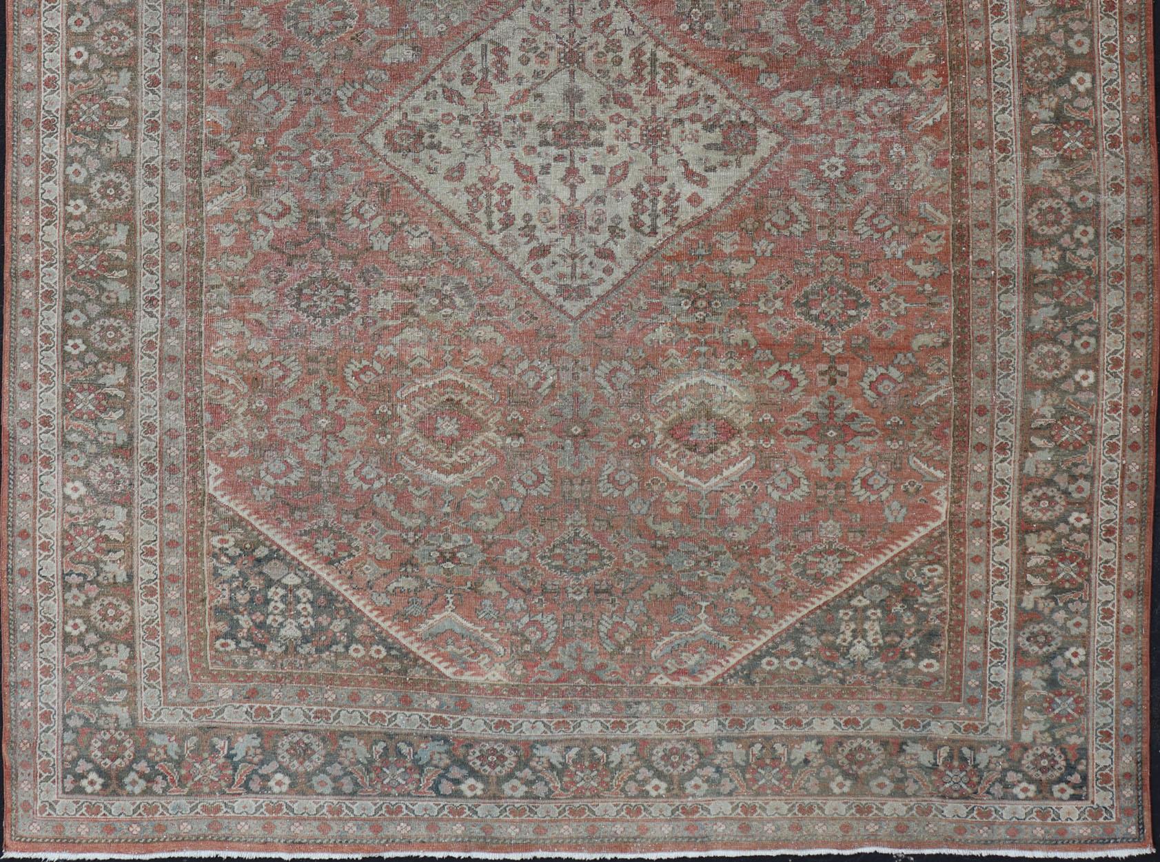 Sultanabad Mahal antique rug from Persia with all-over geometric design, rug L11-0104, country of origin / type: Iran / Mahal, circa 1920 faded red background, charcoal border and multi colors distressed antique Persian Sultanabad rug

This