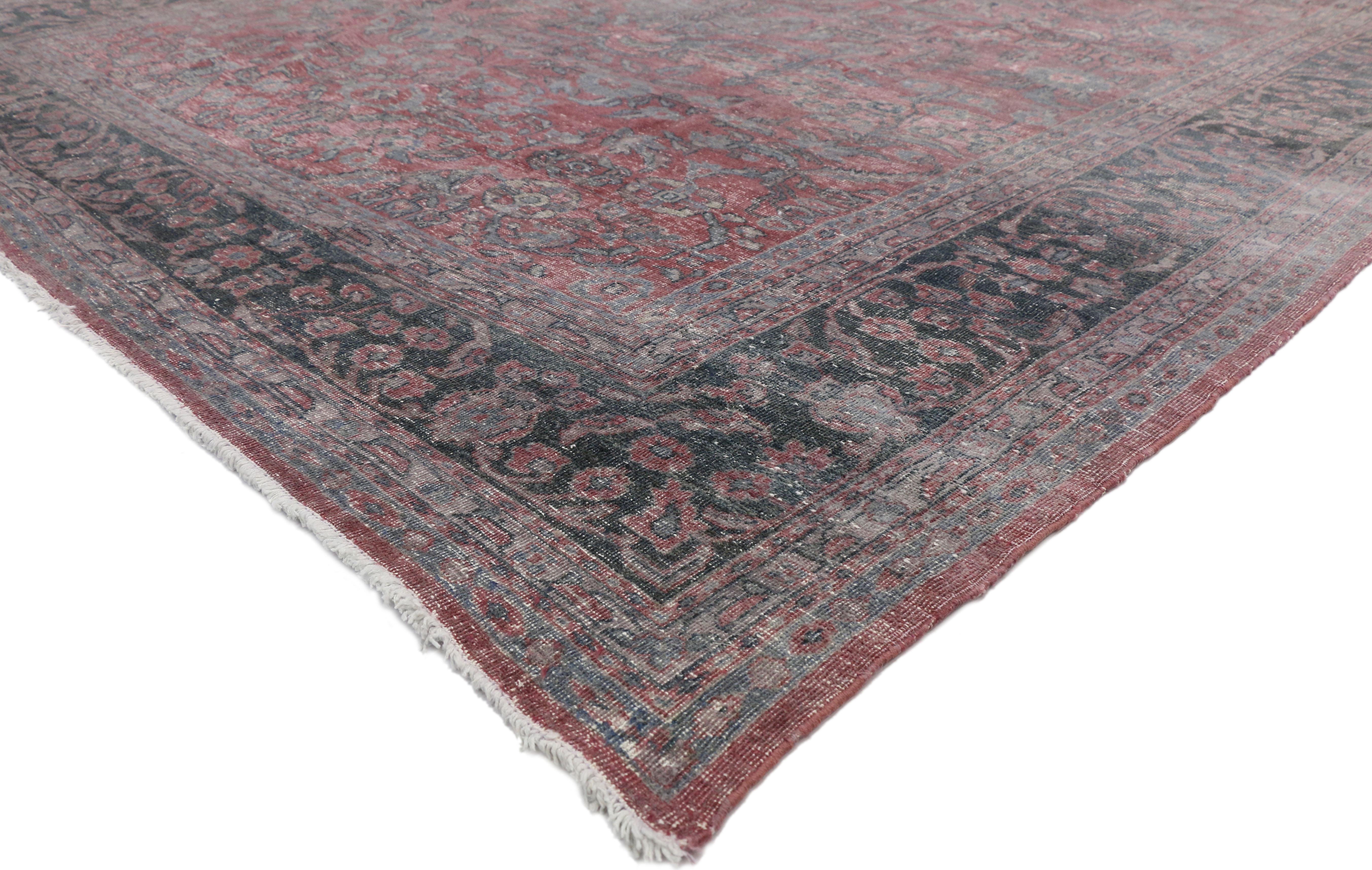 72868 Distressed Antique Persian Tabriz Area Rug with Feminine Industrial Style. This hand-knotted distressed antique Tabriz rug with feminine industrial style features a central medallion surrounded by an all-over floral pattern on a Marsala-wine
