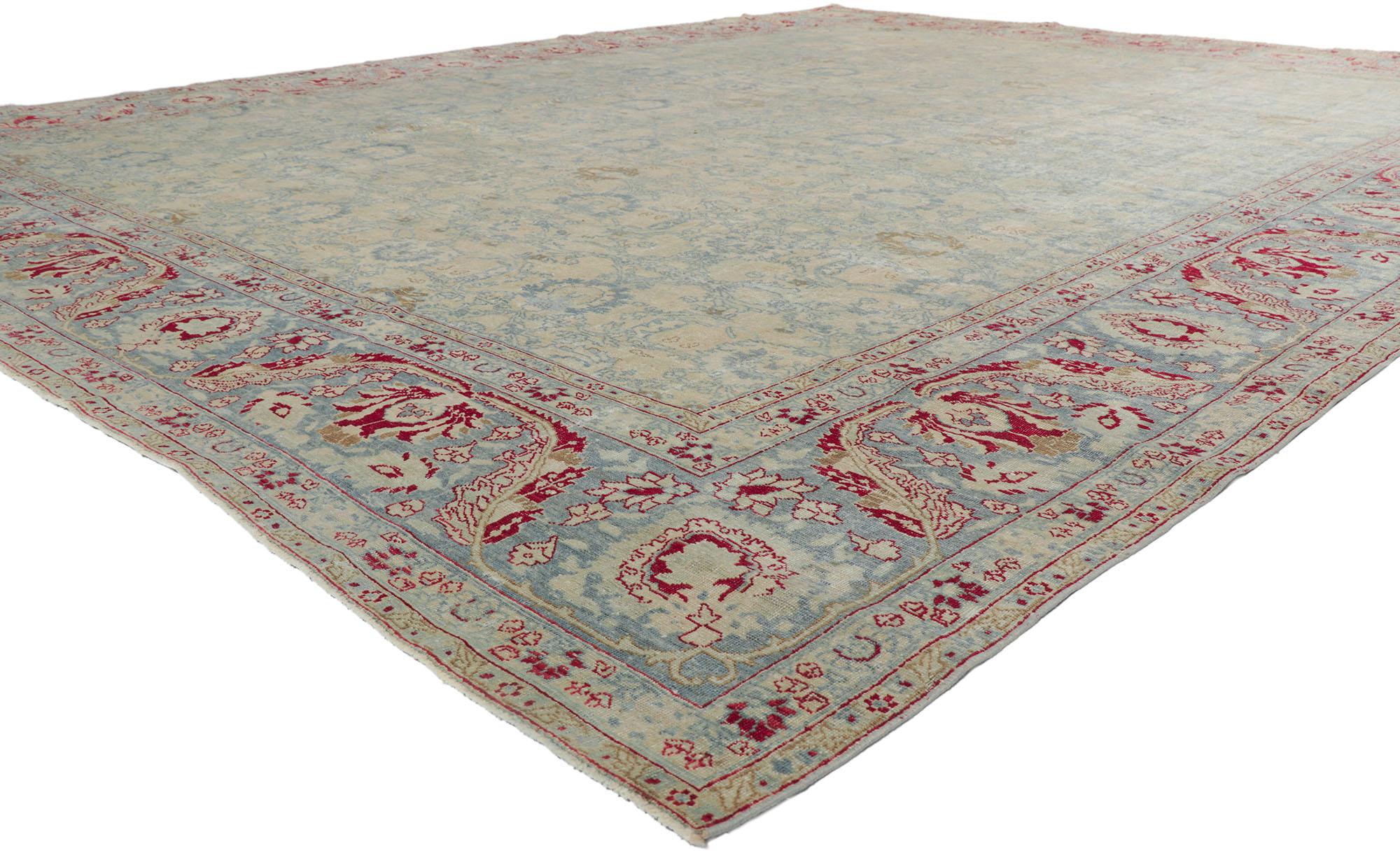 53774 Antique-Worn Persian Tabriz Rug, 11'03 x 14'00.
Experience the epitome of laid-back luxury with a touch of patriotic flair in this exquisite hand-knotted wool distressed antique Persian Tabriz rug. Prepare to be captivated by its intricate