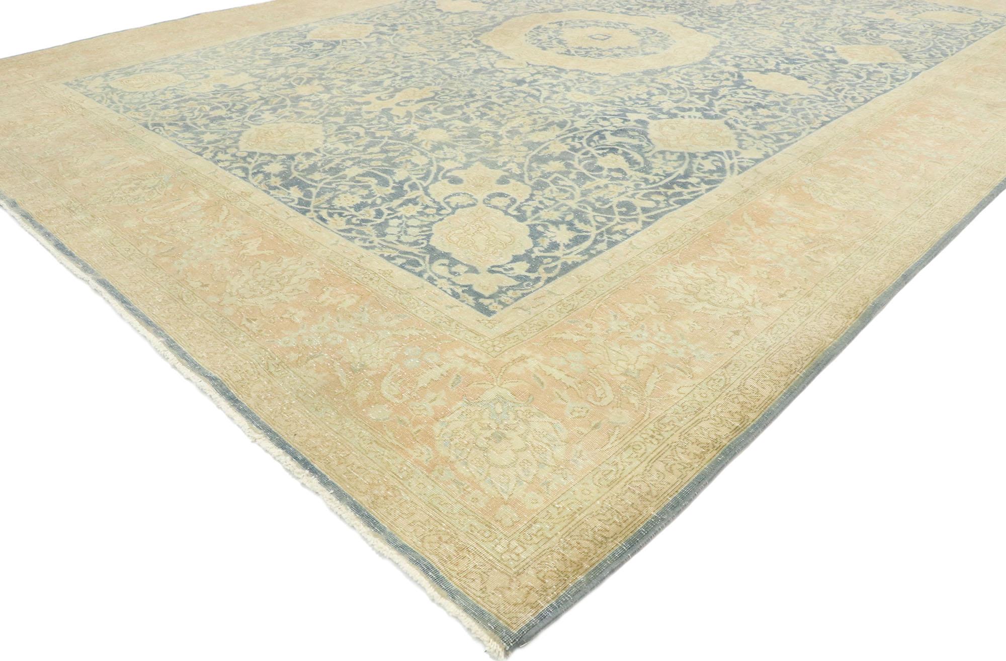 53175, distressed antique Persian Tabriz rug with English Chintz style. With a timeless design and traditional feel, this hand knotted wool distressed antique Persian Tabriz rug beautifully embodies English Chintz style. Taking center stage is a
