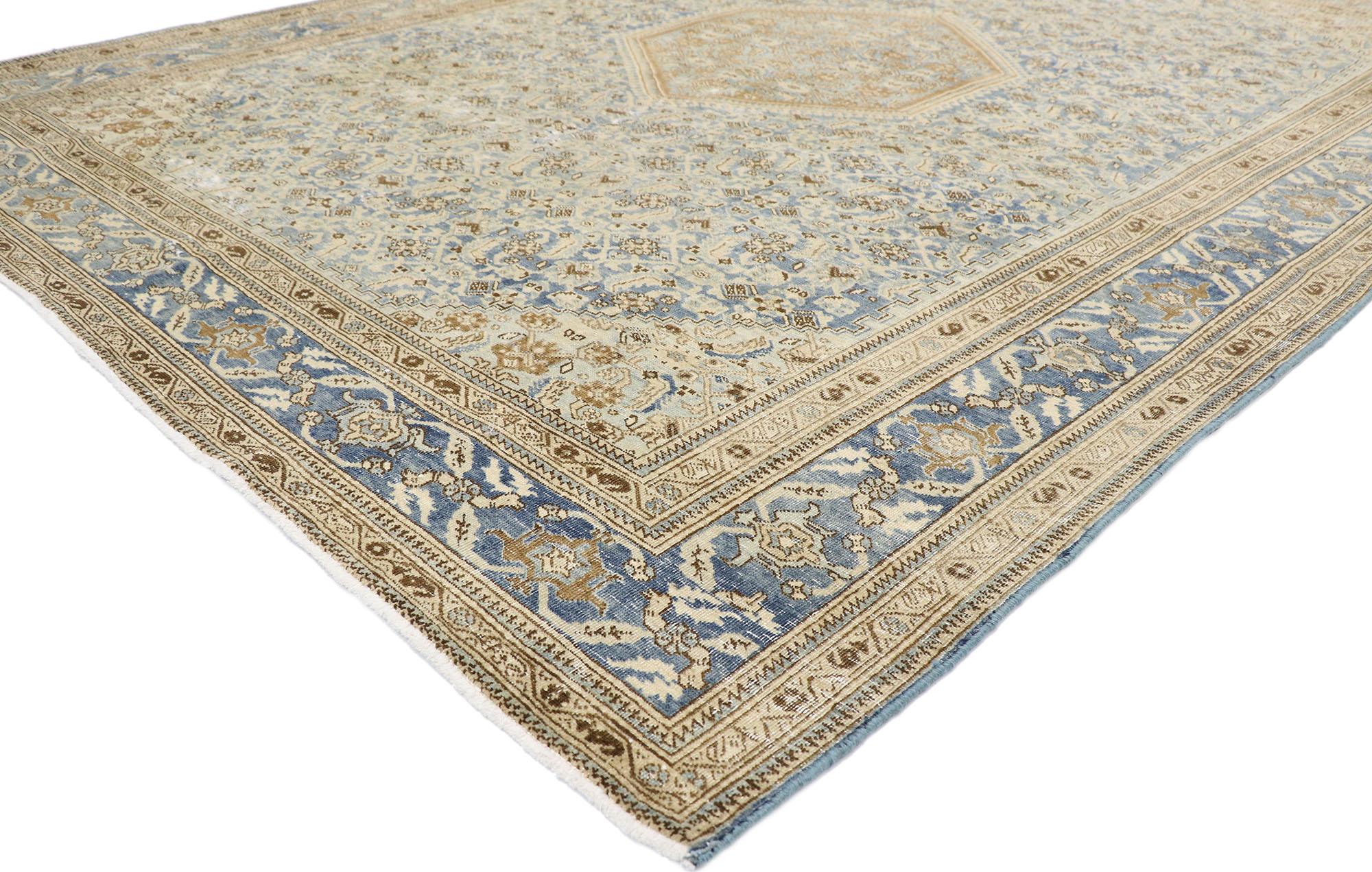 60833, distressed antique Persian Tabriz rug with Rustic Coastal style. Effortlessly chic and emanating coastal vibes with rustic sensibility, this hand-knotted wool distressed antique Persian Tabriz rug is a captivating vision of woven beauty. The