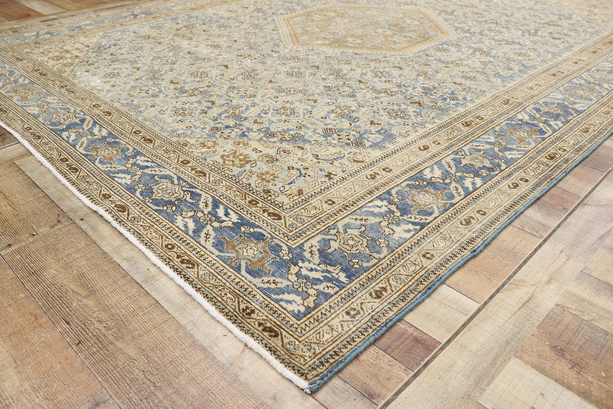 20th Century Distressed Antique Persian Tabriz Rug with Rustic Coastal Style For Sale