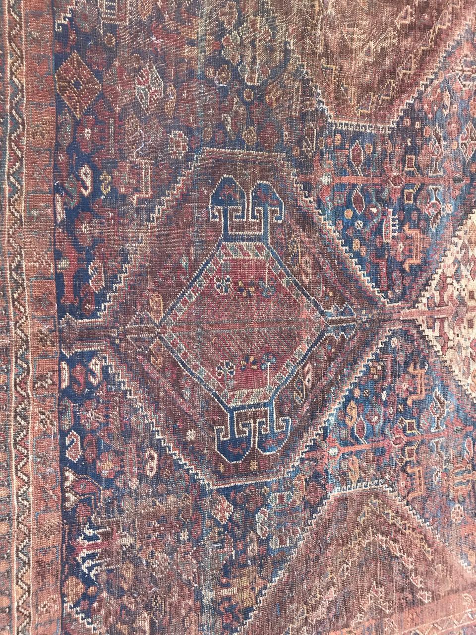Beautiful late 19th century distressed rug with a geometrical tribal design and natural colors, entirely hand knotted with wool velvet on wool foundation.