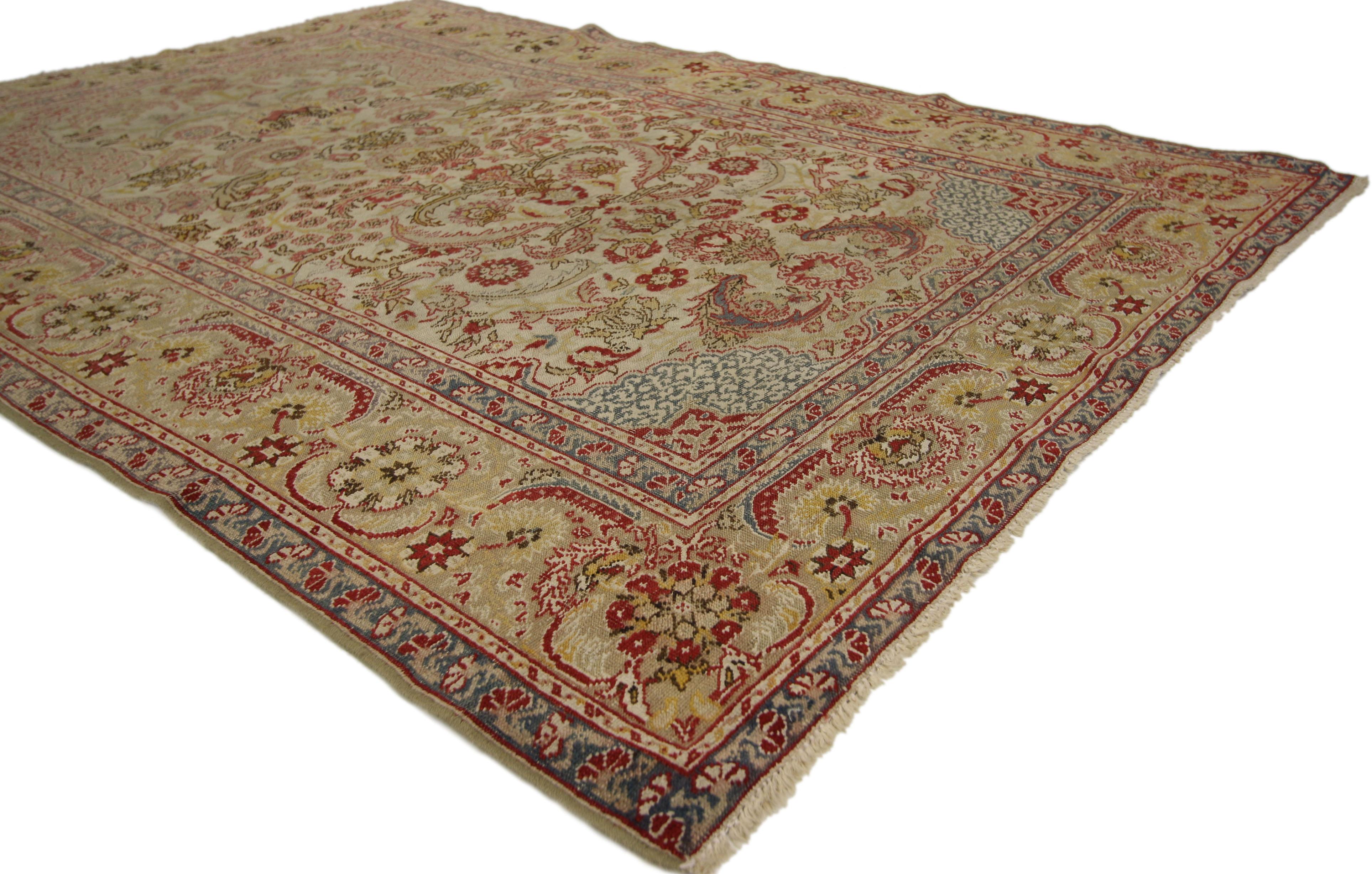 72175 distressed antique Turkish Hereke rug with rustic English Country Cottage style. Soft, bespoke vibes meet English Country Cottage style in this hand knotted wool distressed antique Turkish Hereke rug. The lovingly time-worn field features an