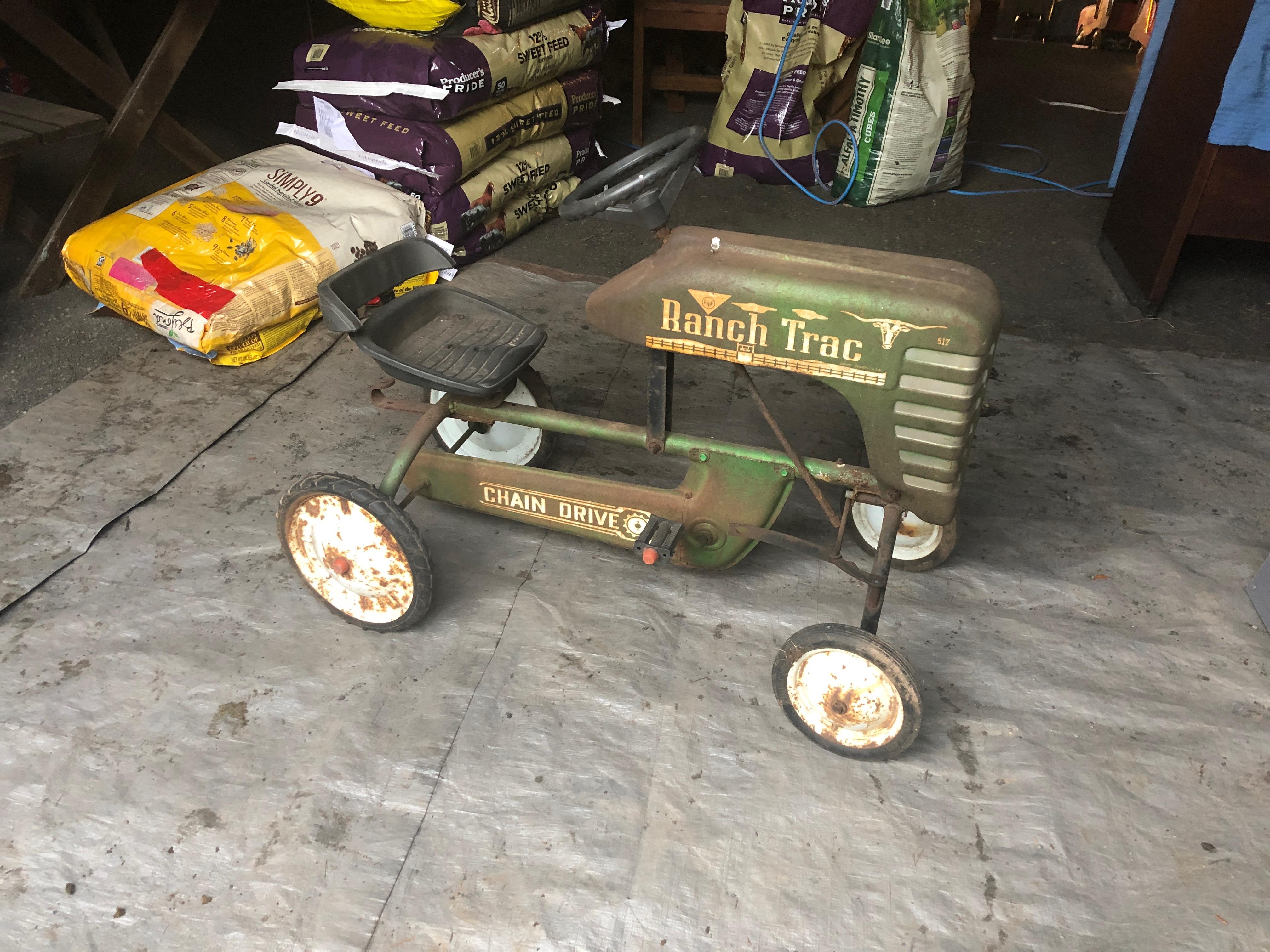 A fabulously distressed old tractor pedal toy car with lots of character and great patina. Meant for display to add a taste of the pasture.