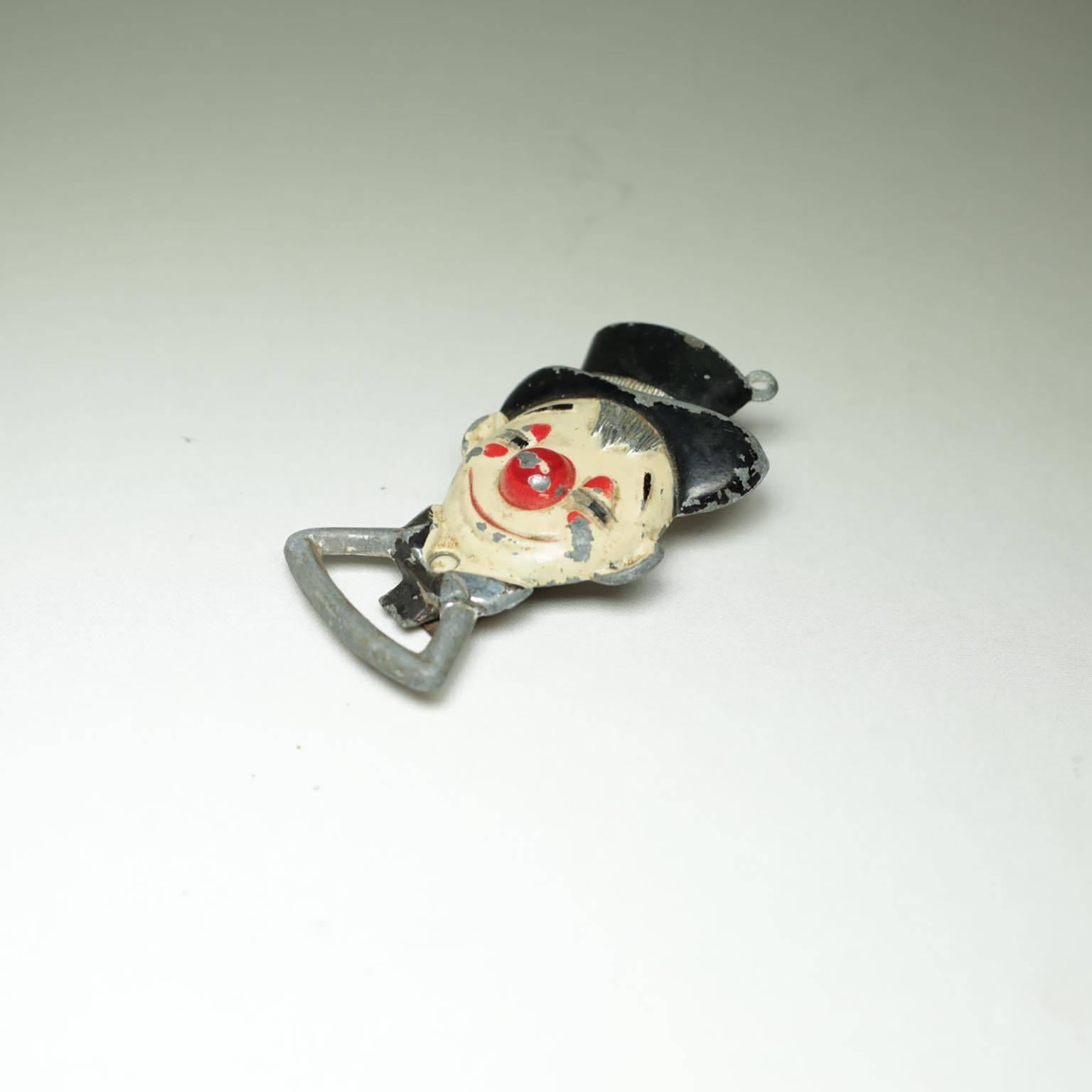 Clown bottle opener with swing around can opener, circa 1940s.