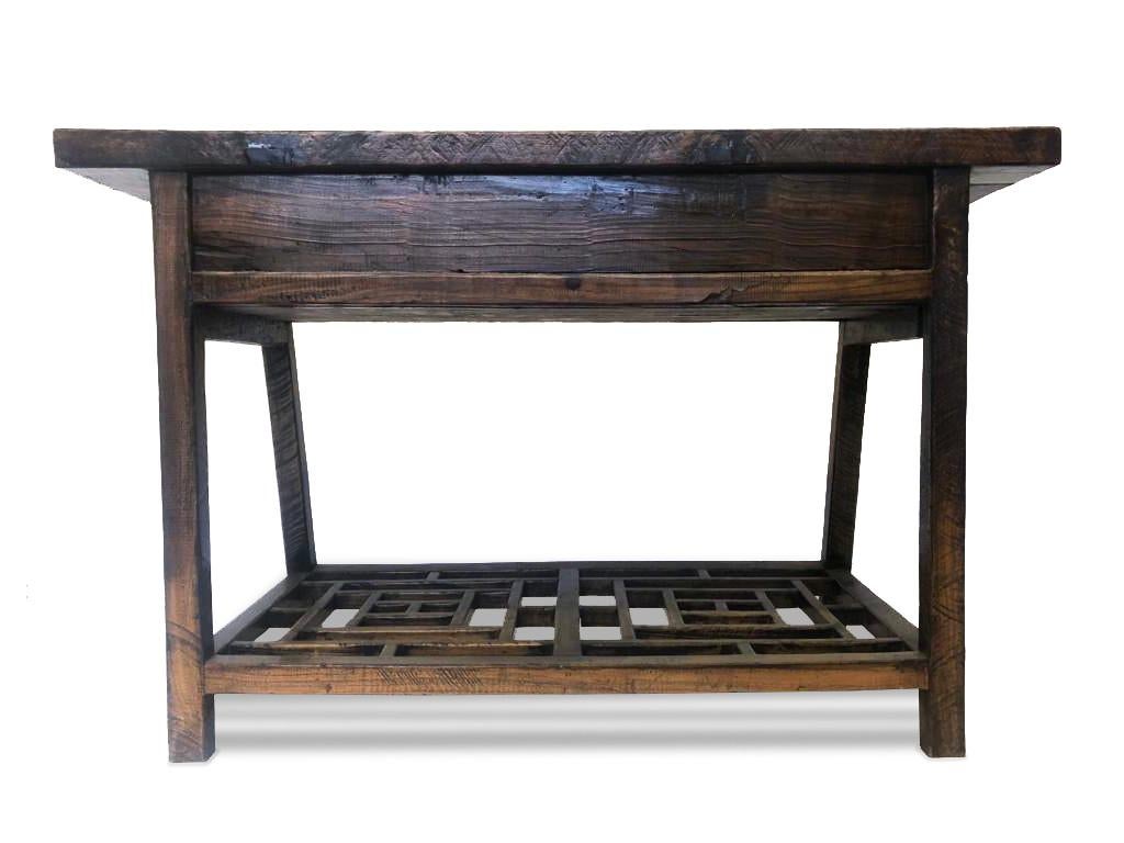 Beautiful carved console/desk from the Philippines. This unique piece comes with a foot rest in elm carved with an elegant ancient pattern. The console has two drawers that maintain the original hardware. 

Property from esteemed interior designer